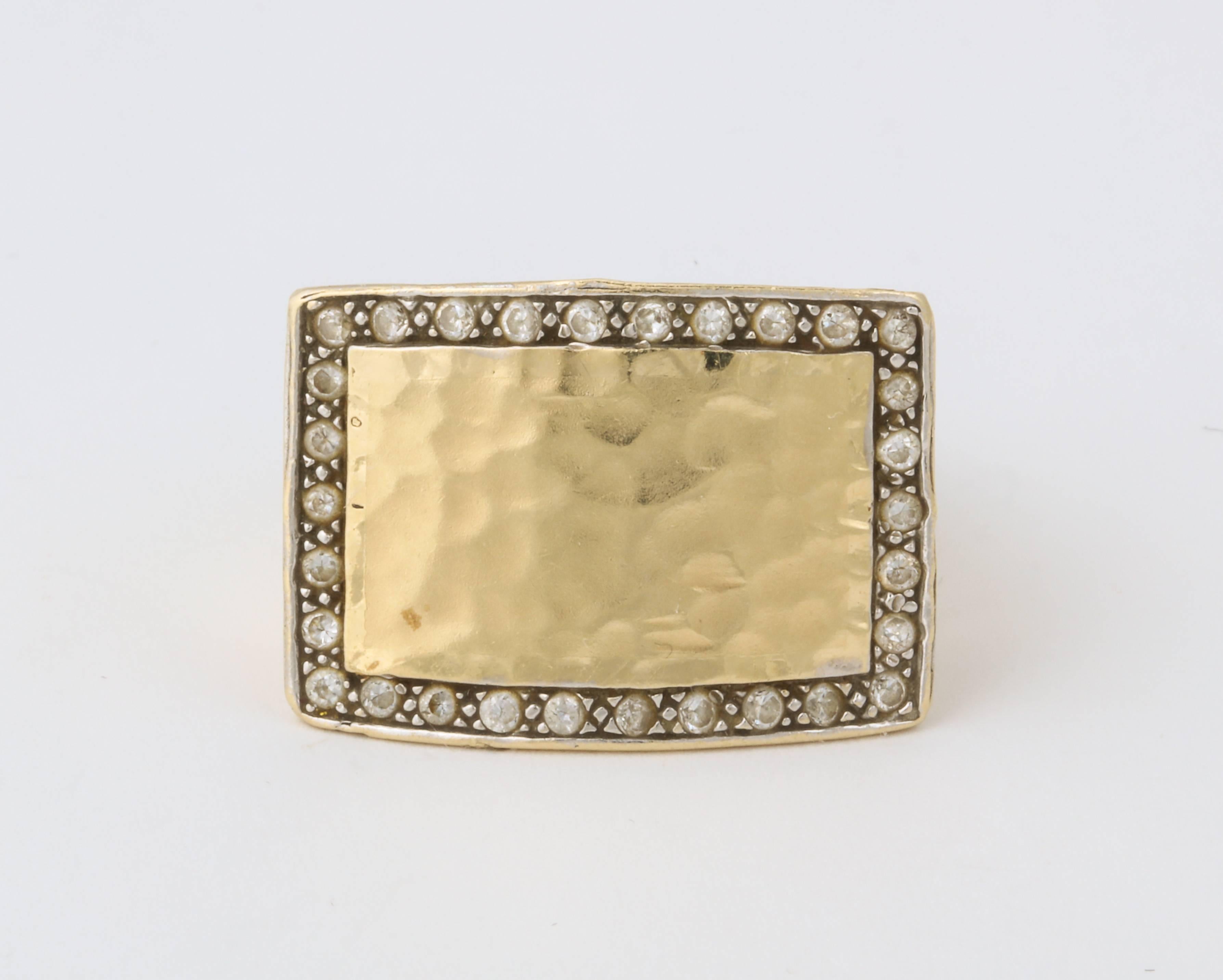 A stylish 18 kt gold ring with a hand hammered matt finish and a border of fine diamonds