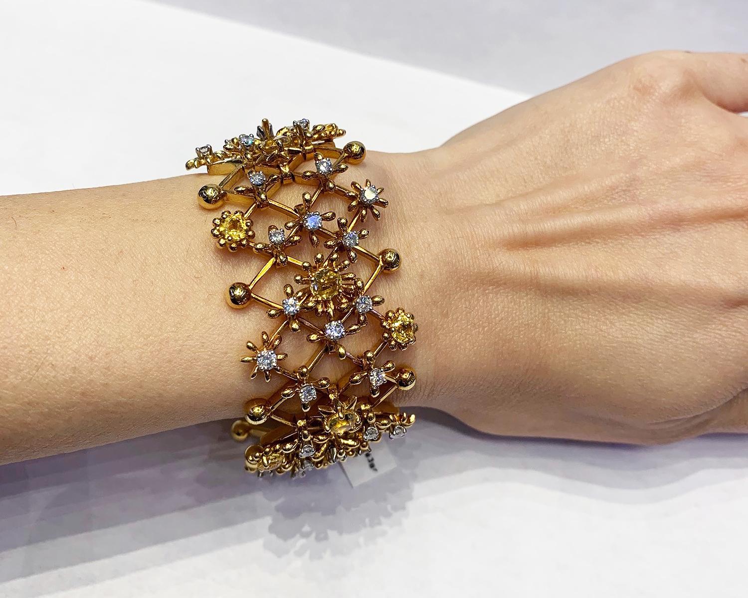 Beautiful bracelet embellished with diamonds and heliodors and set in 18K yellow gold. 
Made by Schlumberger for Tiffany & Co.
The bracelet is of lattice design, the articulated star and floral motifs centering round heliodors and diamonds. The