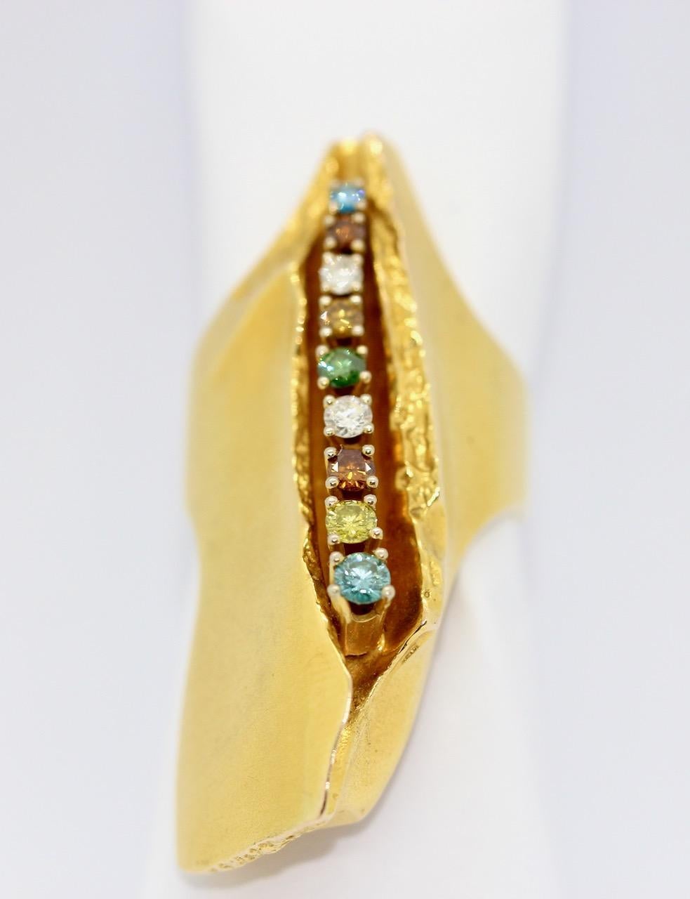 Large, solid designer multi-stone ring by Lapponia, design Björn Weckström, 14k gold.

Set with diamonds and various precious stones. Around 1976.
Hallmarked. Year code Y7.

Length: 47mm; Width: 21.6mm

Includes certificate of authenticity.
