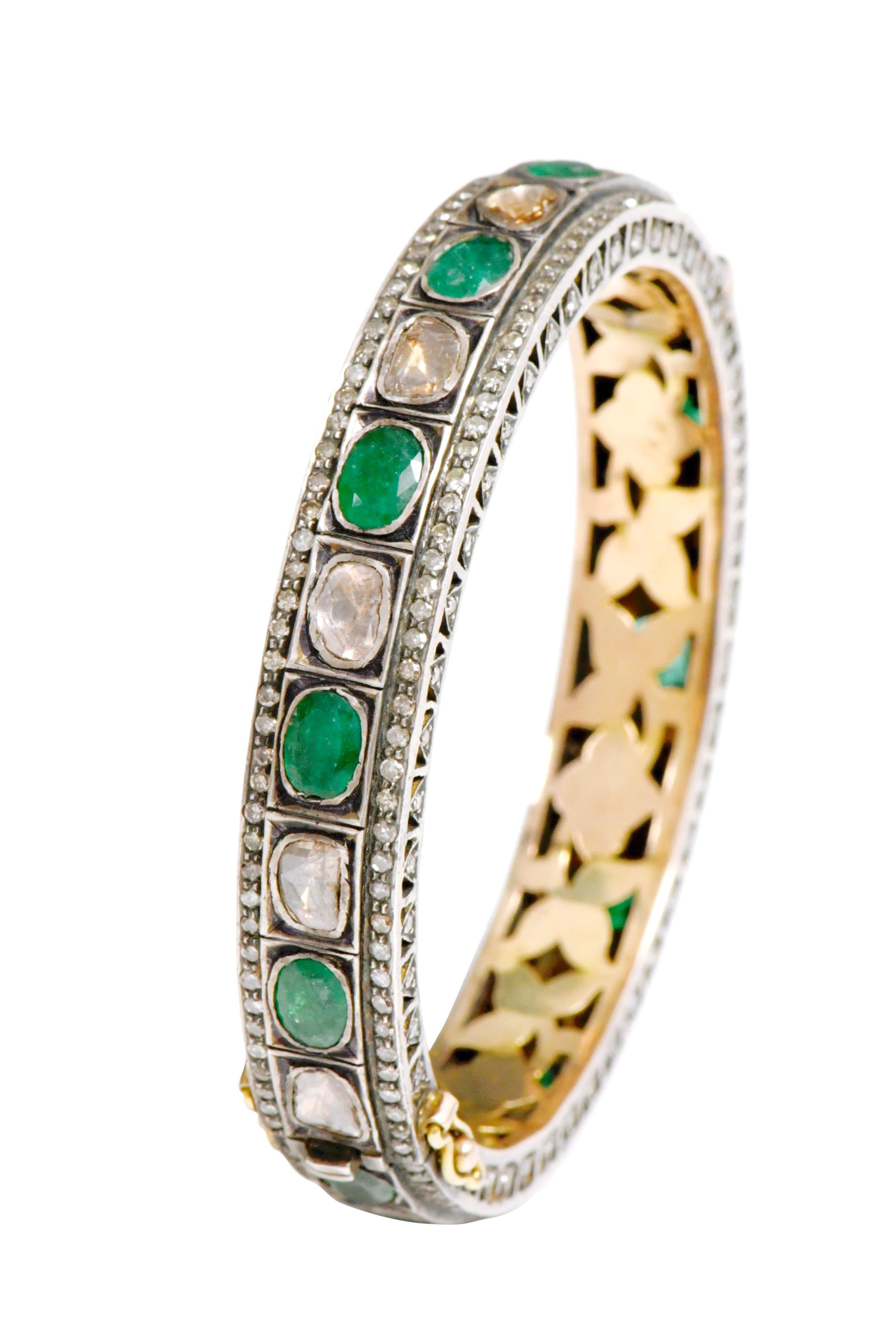 Diamond and Natural Emerald Tennis Bangle in Art-Deco Style 

This Victorian period art-deco atypical polki diamond and forest green emerald bangle is incredible. The uneven triangle and U-cut flat polki diamond solitaires alternated with oval shape