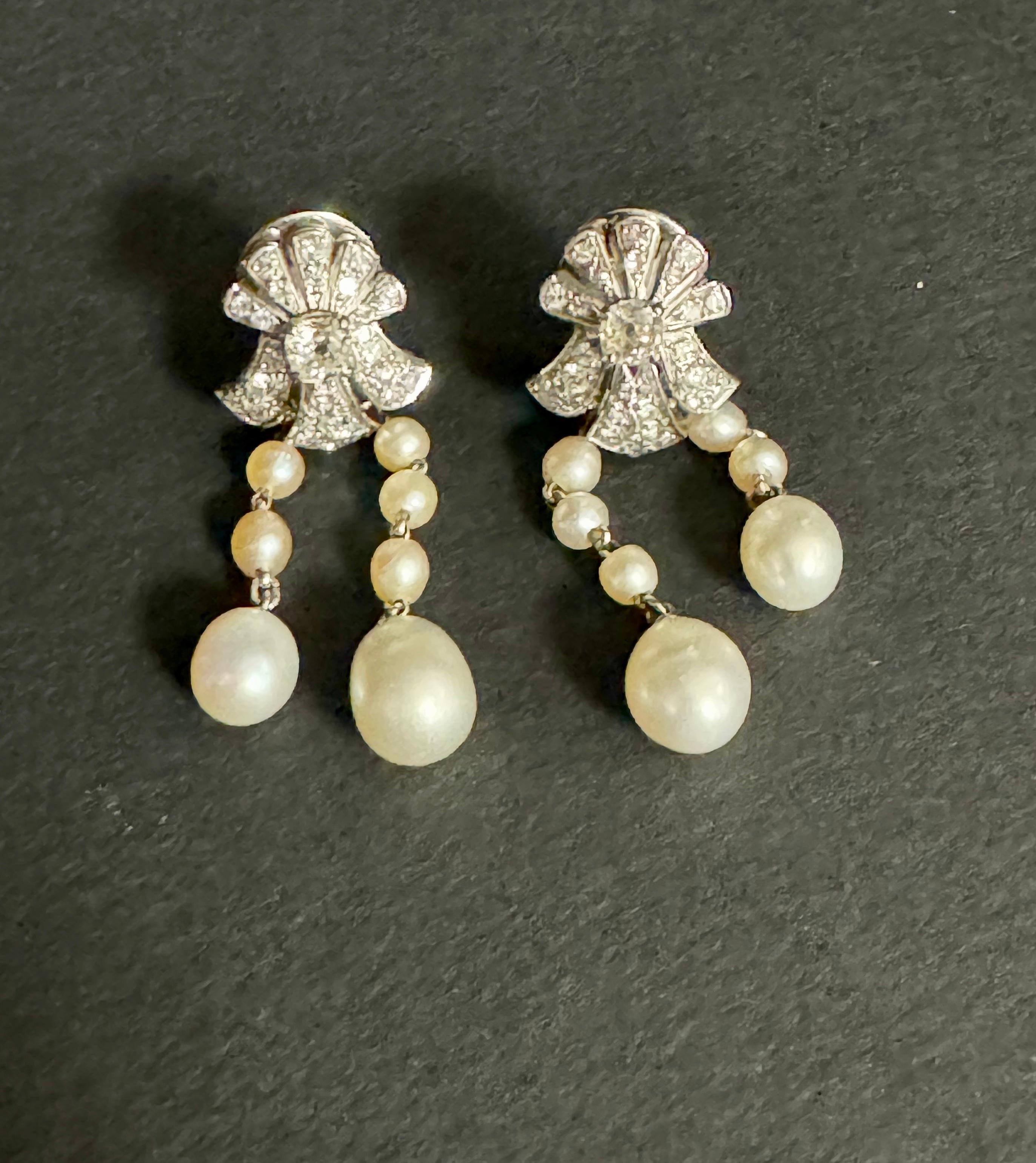 Elegantes Paar Ohrringe aus Diamanten und natürlichen Perlen.

Die Perlen wurden von dem berühmten französischen Schriftsteller Henry de Monfreid (1879-1974) gefischt und seiner Frau geschenkt. 

Die Diamanten sind mit altem Schliff auf 18k Graugold
