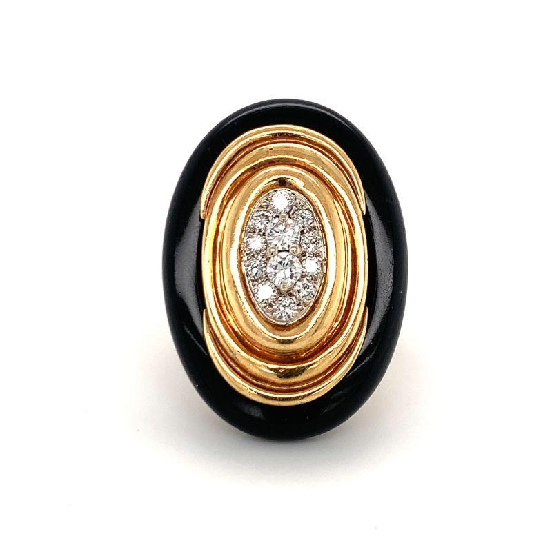 This glamorous and impressive 1970s Emis diamond and black onyx ring exudes elegance and sophistication. Crafted in 18K yellow gold, the ring centers on 0.75 carats of pave-set round brilliant cut diamonds graded G-H in color and VS-2 in clarity,