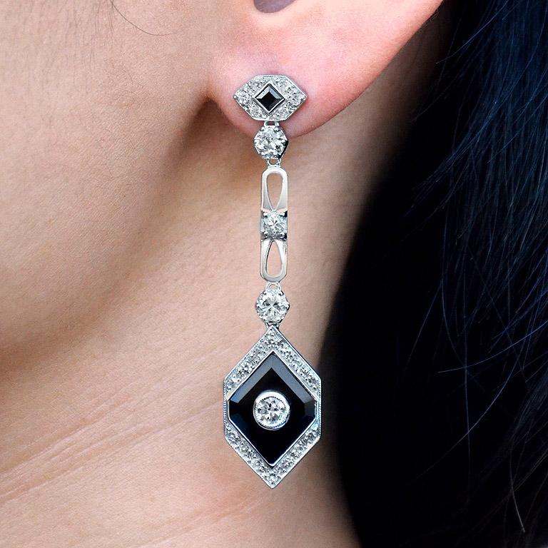 Breathtaking diamond and onyx drop earrings which are a stunning example of Art Deco design jewelry. Simply stunning geometric design drop earrings set with a combination of glistening round diamond with a perfectly contrasting deep black onyx