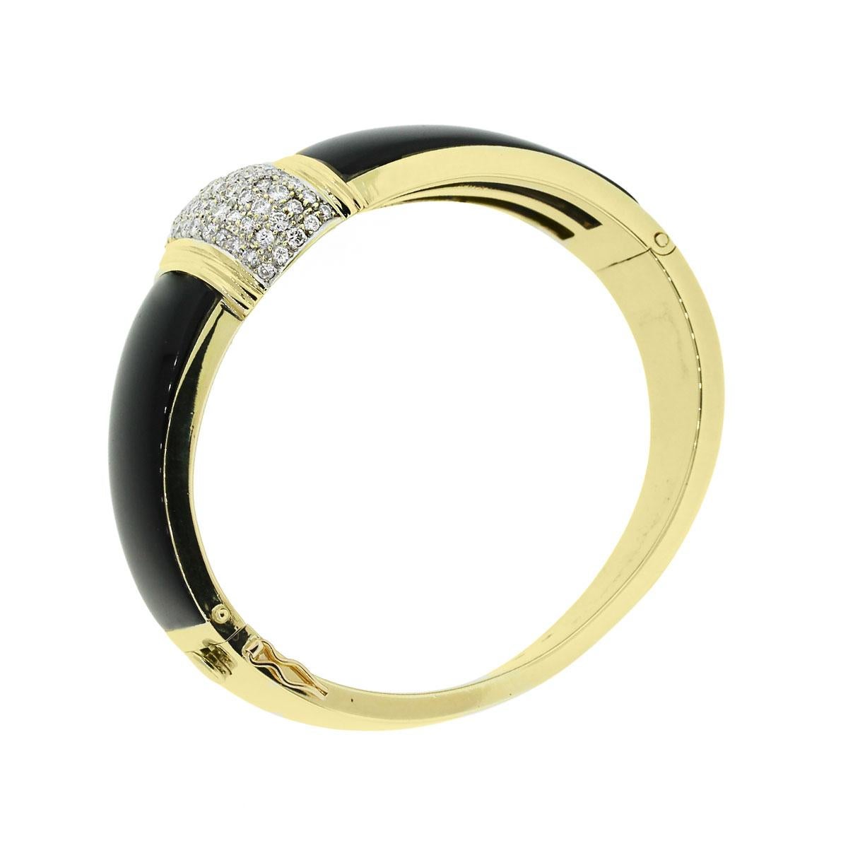 Material: 18k yellow gold
Diamond Details: Approximately 2ctw of round brilliant diamonds. Diamonds are H in color and SI1 in clarity
Gemstone Details: Onyx
Total Weight: 71.5g (46dwt)
Bracelet Measurements: 6.25″ x 1.03″ x 2.50″
Clasp Details:
