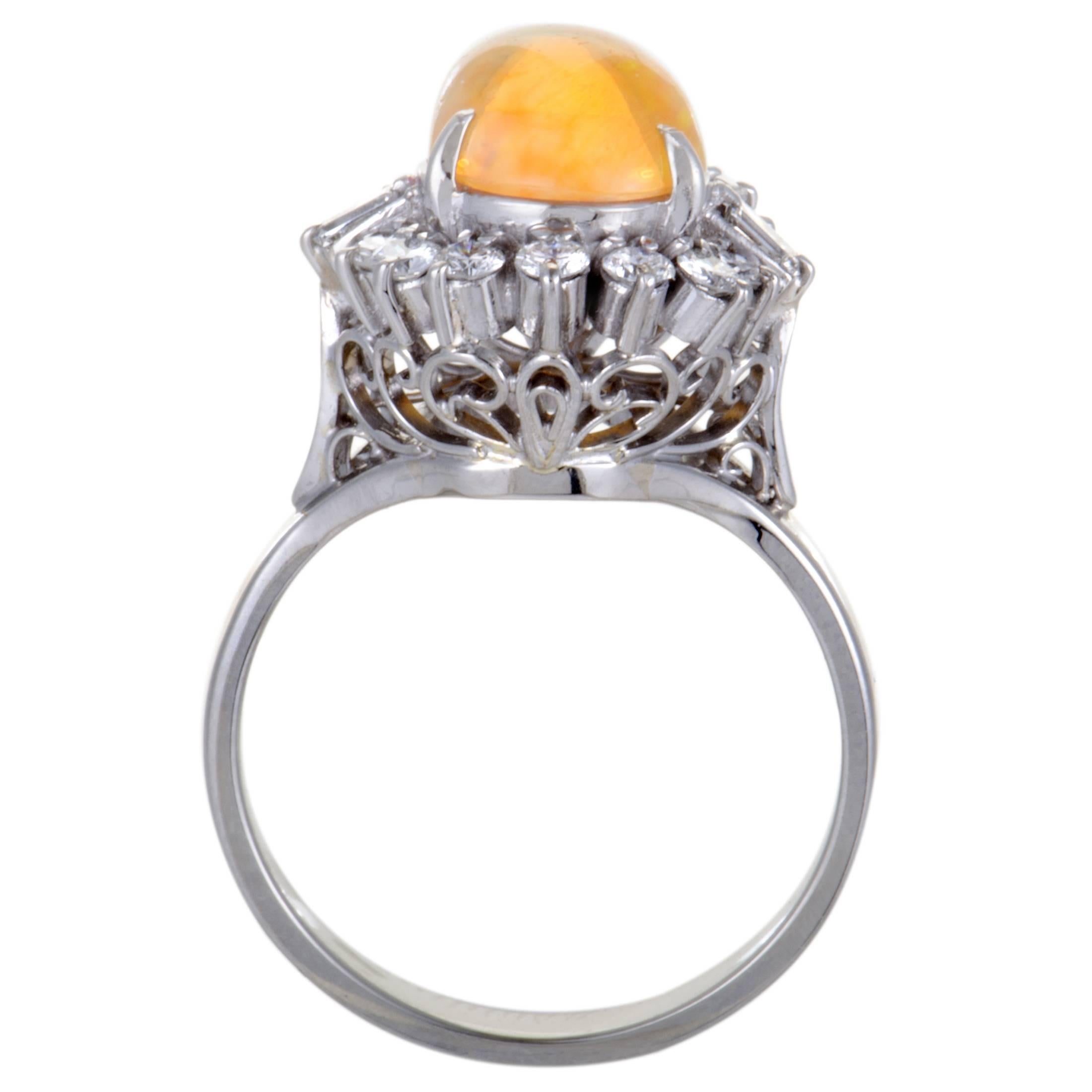 Extravagantly designed in shimmering platinum, this opulent ring is a blend of elegance and style. The glamorous ring is adorned in a sparkling pave of 0.53ct diamonds surrounding a mesmerizing yellow fire opal that makes the piece alluring and a
