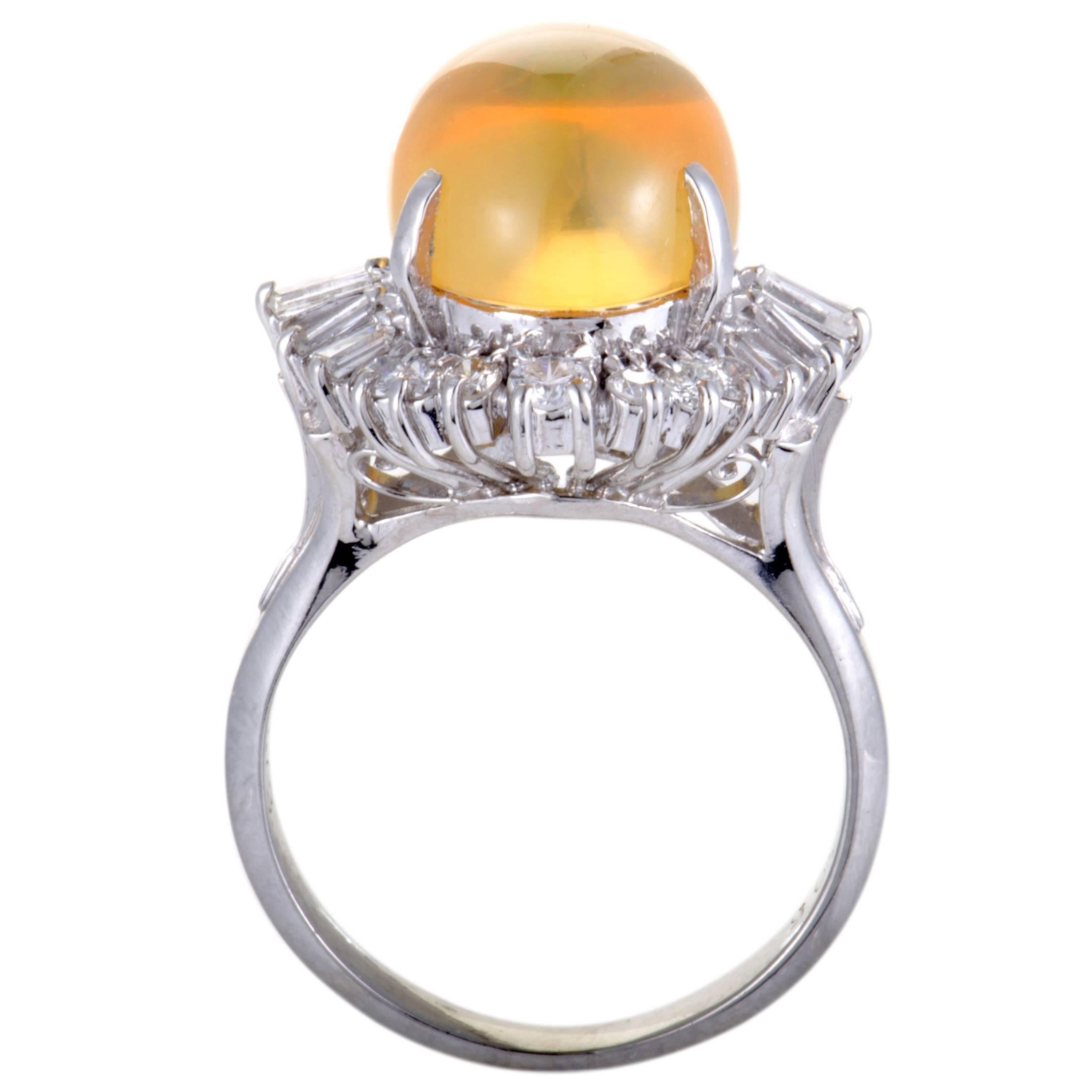 Exquisitely designed and beautifully decorated, this fabulous ring is made in attractive platinum. The stunning ring features a captivating yellow fire opal, weighing 6.05ct, surrounded by 0.73ct of dazzling diamonds that boast an exceptionally