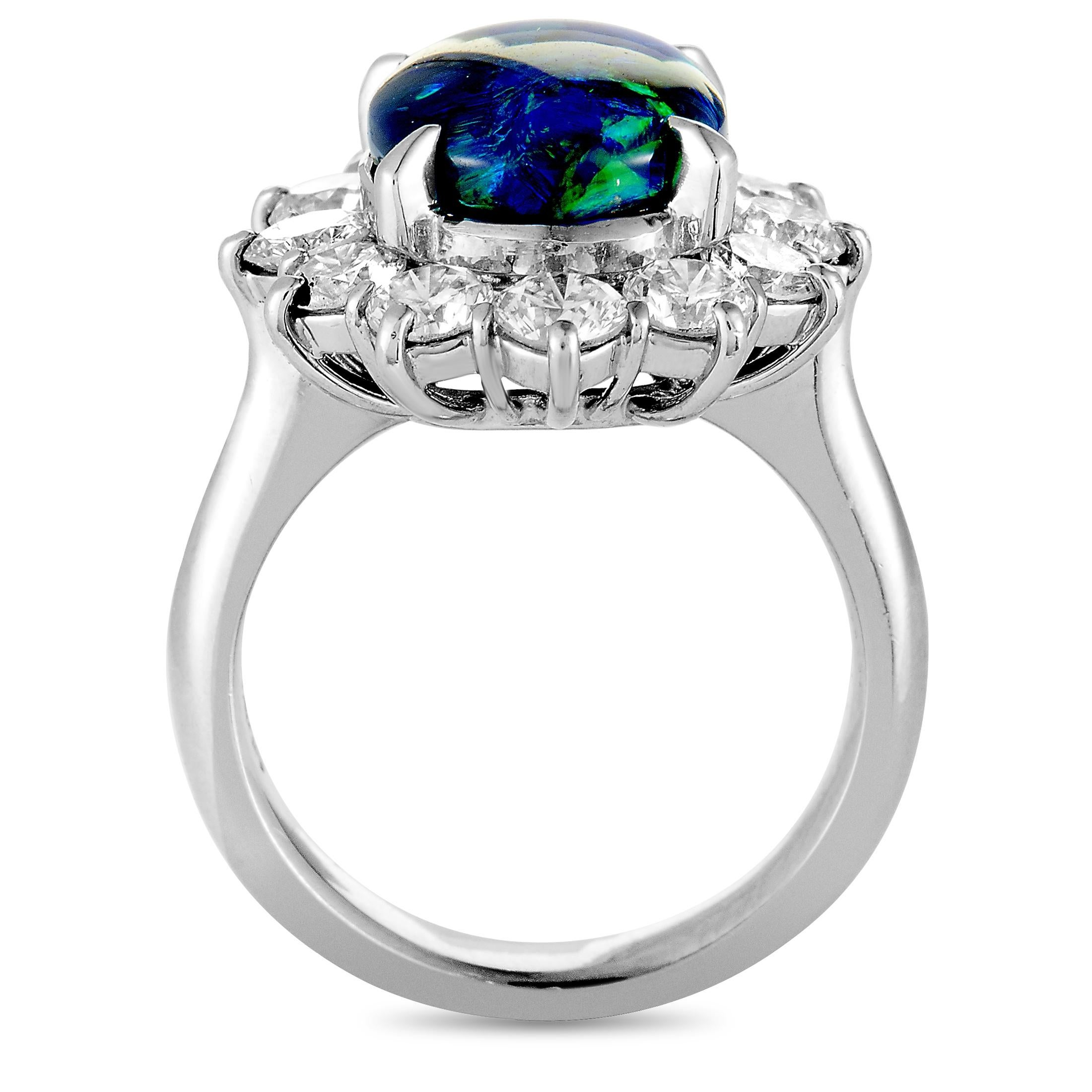 This ring is made of platinum and weighs 10.7 grams. It boasts band thickness of 4 mm and top height of 9 mm, while top dimensions measure 17 by 19 mm. The ring is set with an opal that weighs 2.71 carats and with diamonds that total 1.91