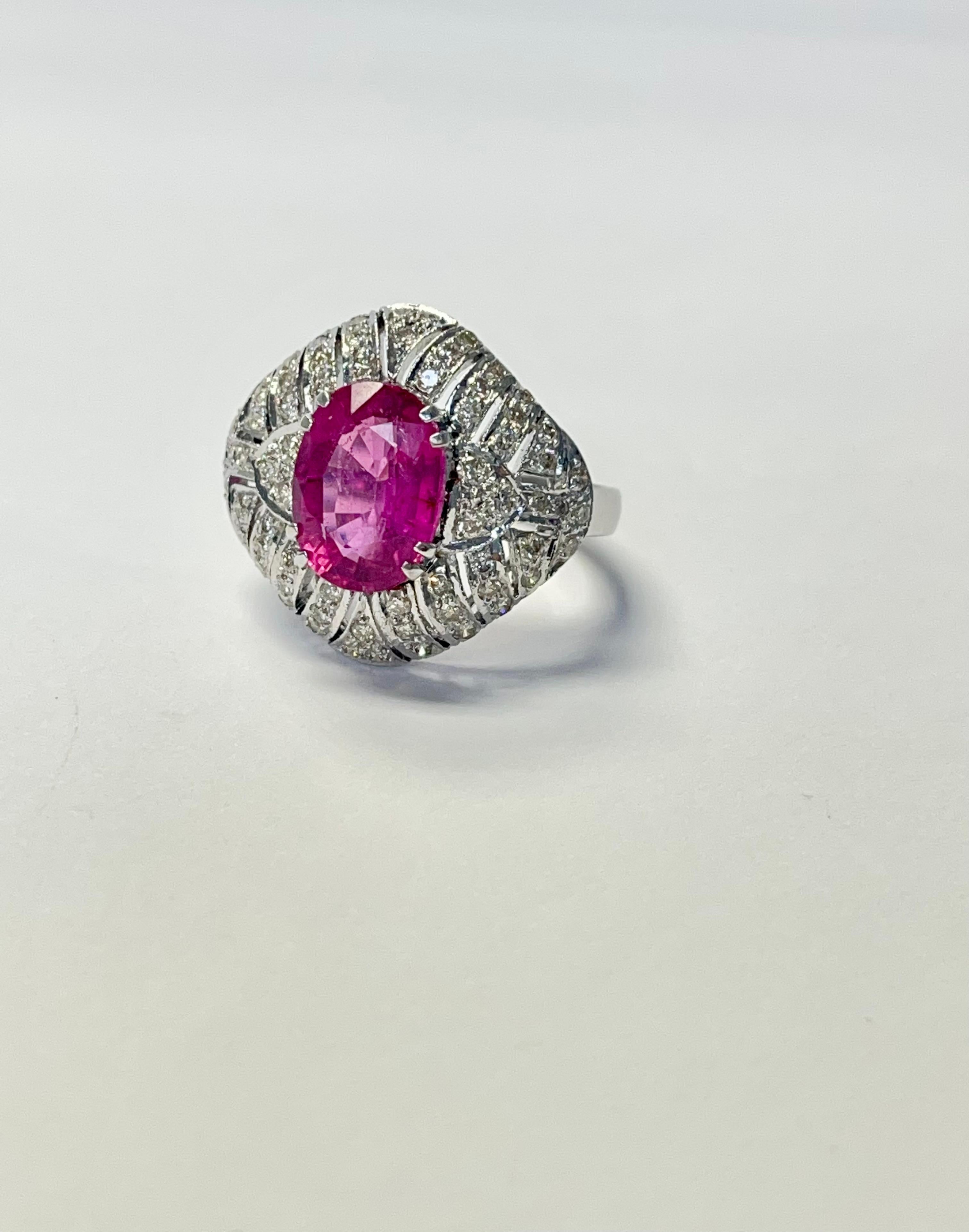 Diamond And Rubellite Engagement Ring In 18K White Gold. 

The details are as follows : 
Oval Rubelite weight : 3.30 carats 
Diamond weight : 1.32 carat ( GH color and VS clarity ) 
Gold : 18k white gold 
Measurements : 0.50 to 1 inch ( Ring head ) 