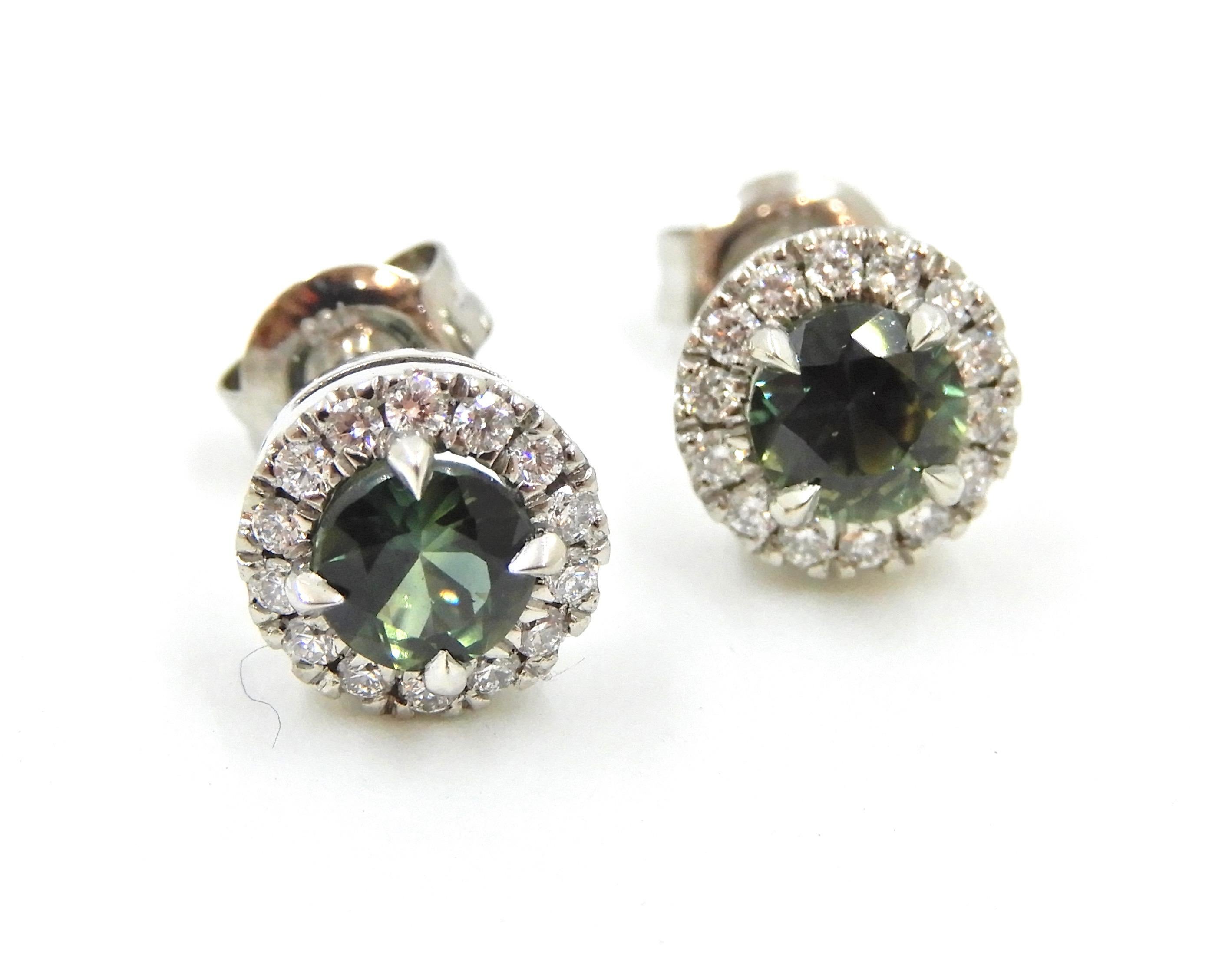 This gorgeous pair of Diamond and Parti Sapphire 18 Carat White Gold Stud Earrings are stunning as the central Australian parti sapphire takes centre stage. 

The central 4 claw set, round cut, blue-green parti sapphires (2 in total) are each