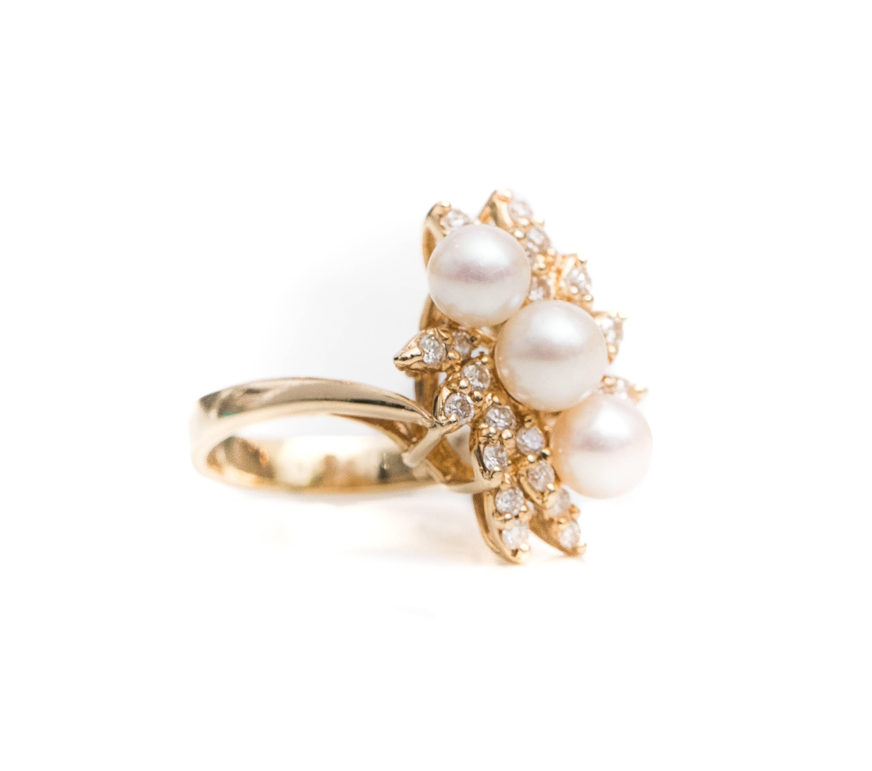 Cardow Diamond, Pearl and 14 Karat Yellow Gold Cocktail Ring

Features 3 round, white pearls and 0.25 carat total weight Round Brilliant Diamonds set in a 14 Karat Yellow Gold bypass design. 
The pearls are set in a horizontal line across the ring