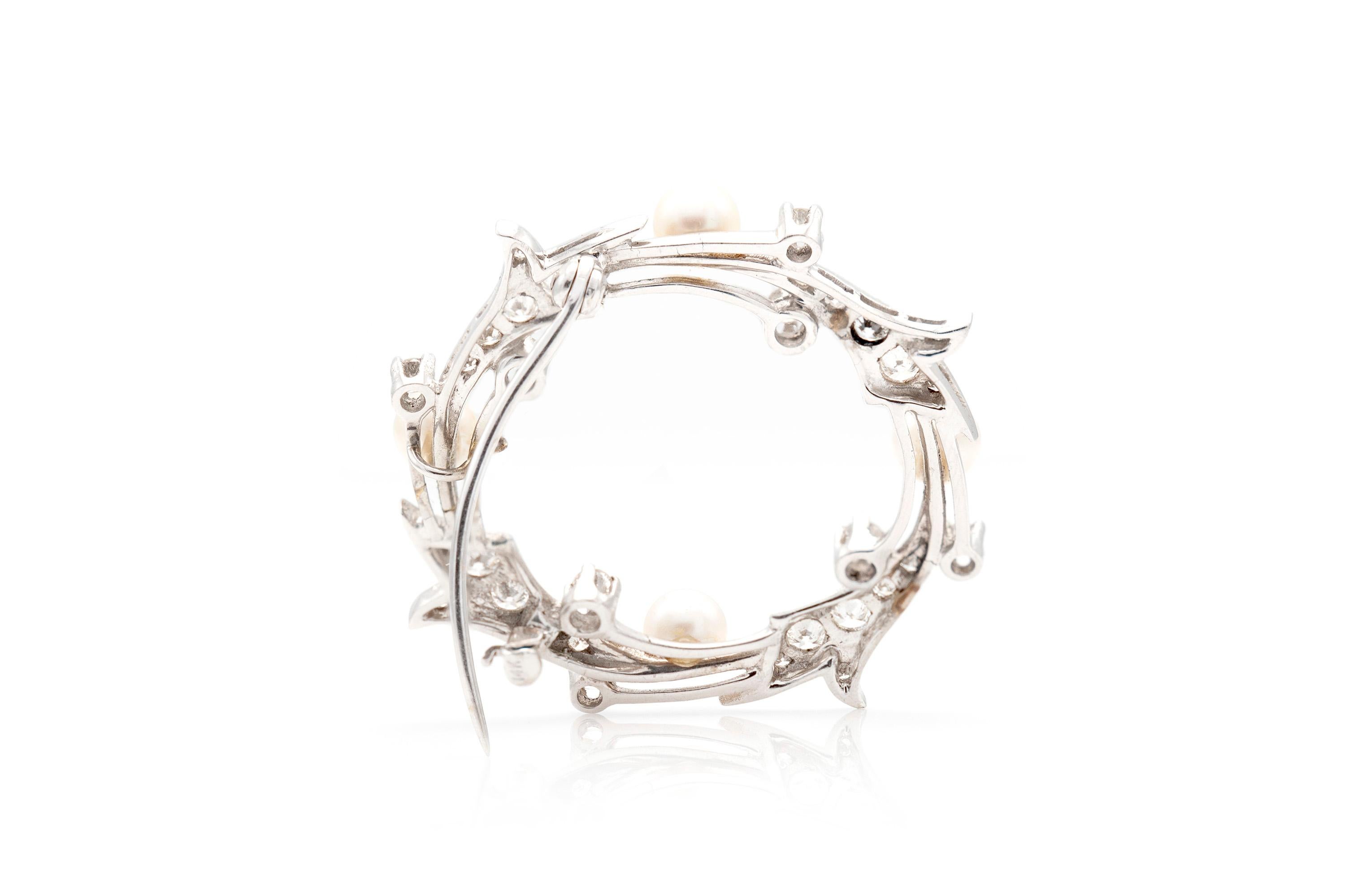 Finely crafted in platinum with pearls and approximately 2.00 carats of diamonds.