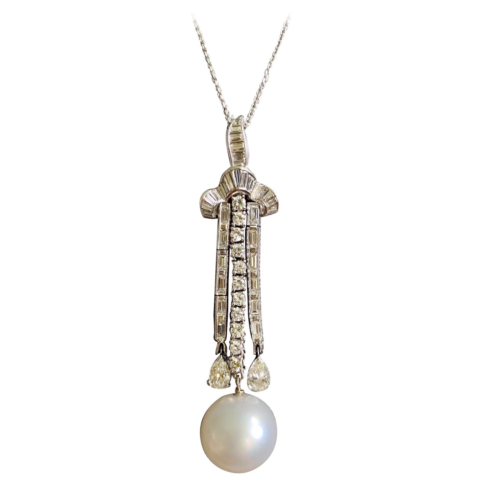 This spectacular Platinum Lavalier pendant has three dangly strands of diamonds, one of which in the center, leads to a large round pearl at the end of the strand of diamonds.  The other two strands of diamonds lead to nice pear-shaped diamonds. 
