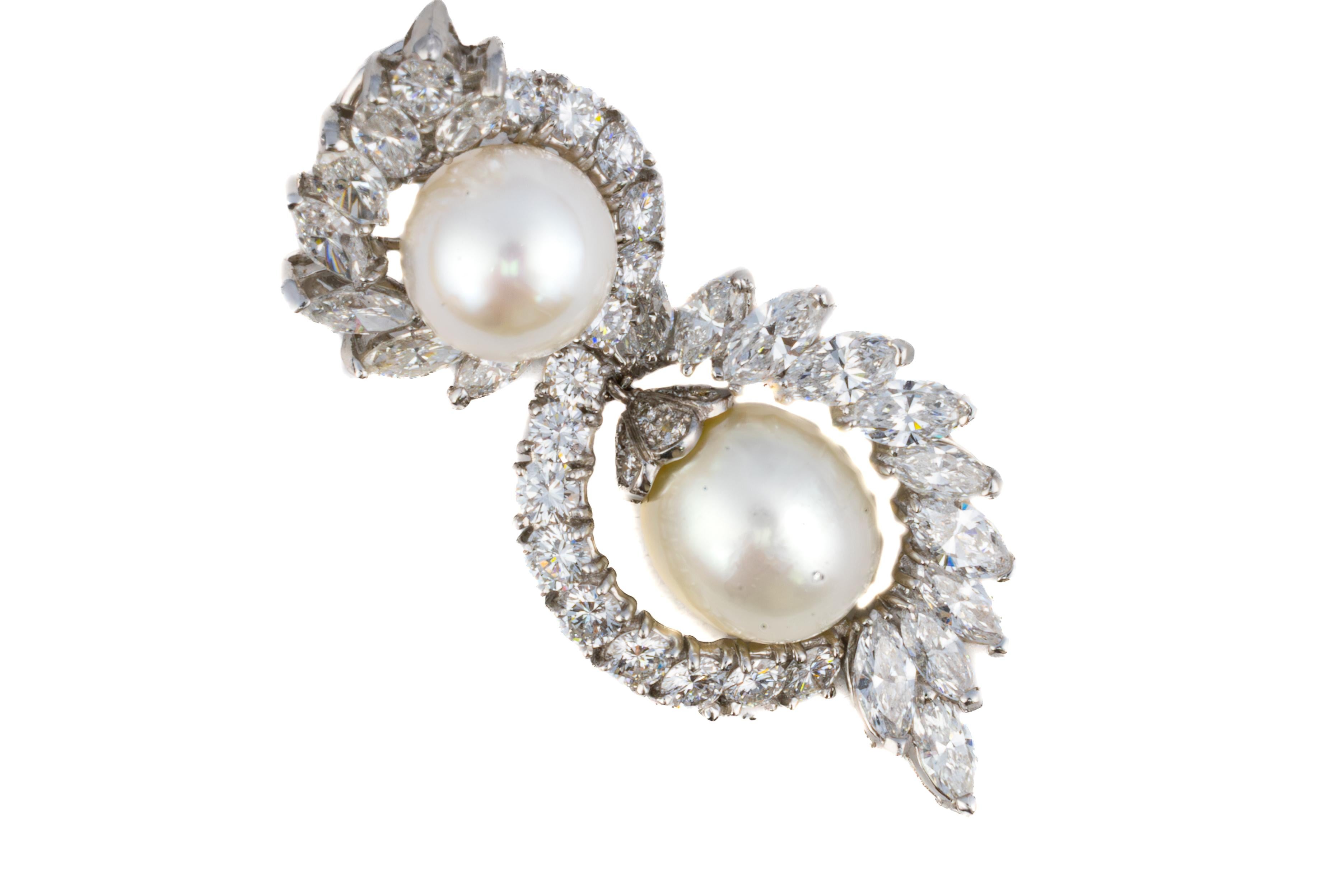 Diamond and Pearl Double Swirl Earrings

Description:
Graceful and dramatic, these earrings feature a captivating double swirl silhouette adorned with marquise and round diamonds that gracefully curve around luminous pearls. Each earring is set with