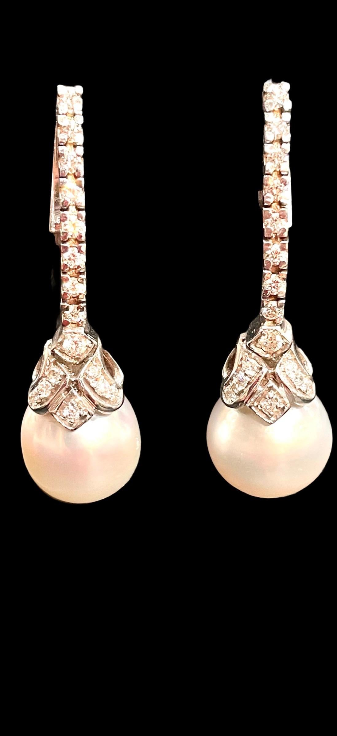 HK Fine Estate Jewels is pleased to present these stunning French pearl pendant earrings. Each earrings is set with a white cultured pearl with excellent luster to a brilliant-cut diamond surmount and are approximately 42mm. These are marked with 