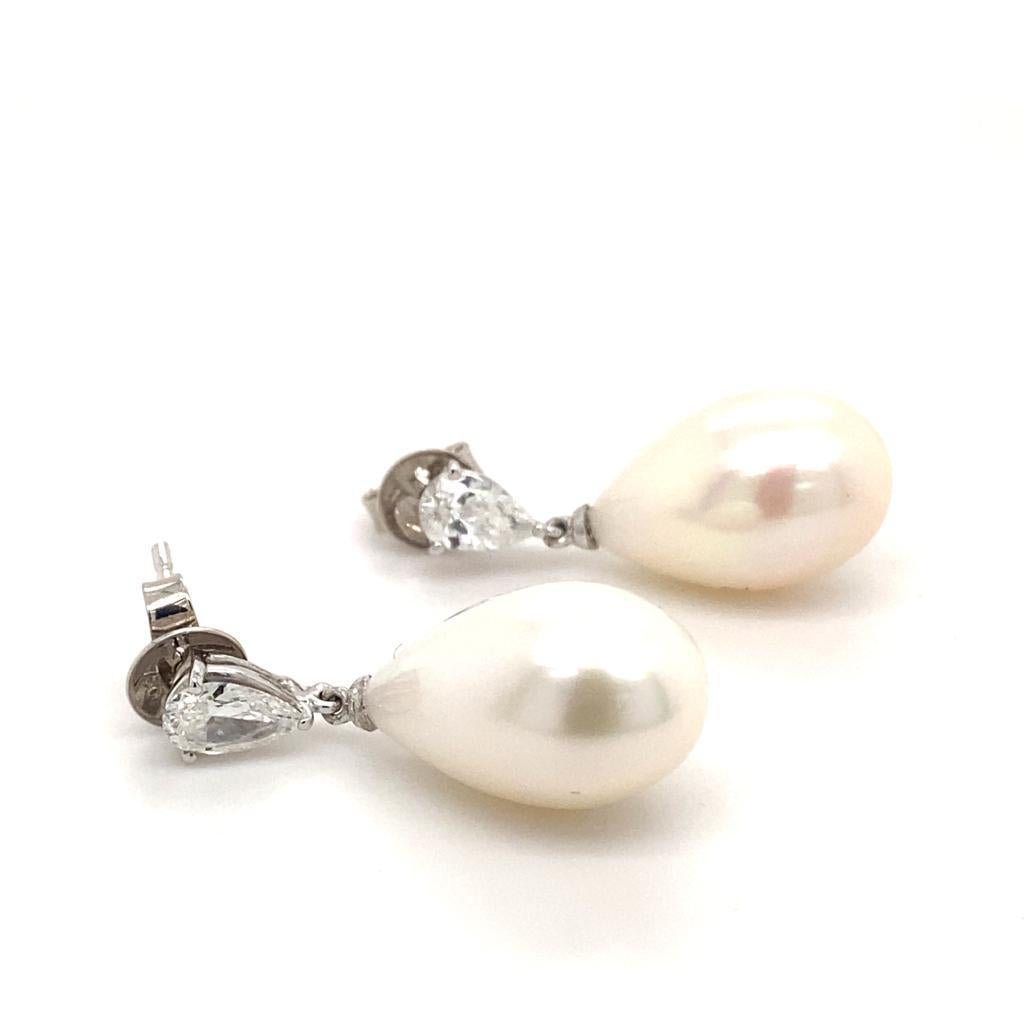 A pair of diamond and pearl drop earrings in 18 karat white gold.

Each classic and contemporary earring is designed as a pear shaped cultured pearl suspended from a matching pear brilliant cut diamond of 0.31 carats.

The simplicity of the design