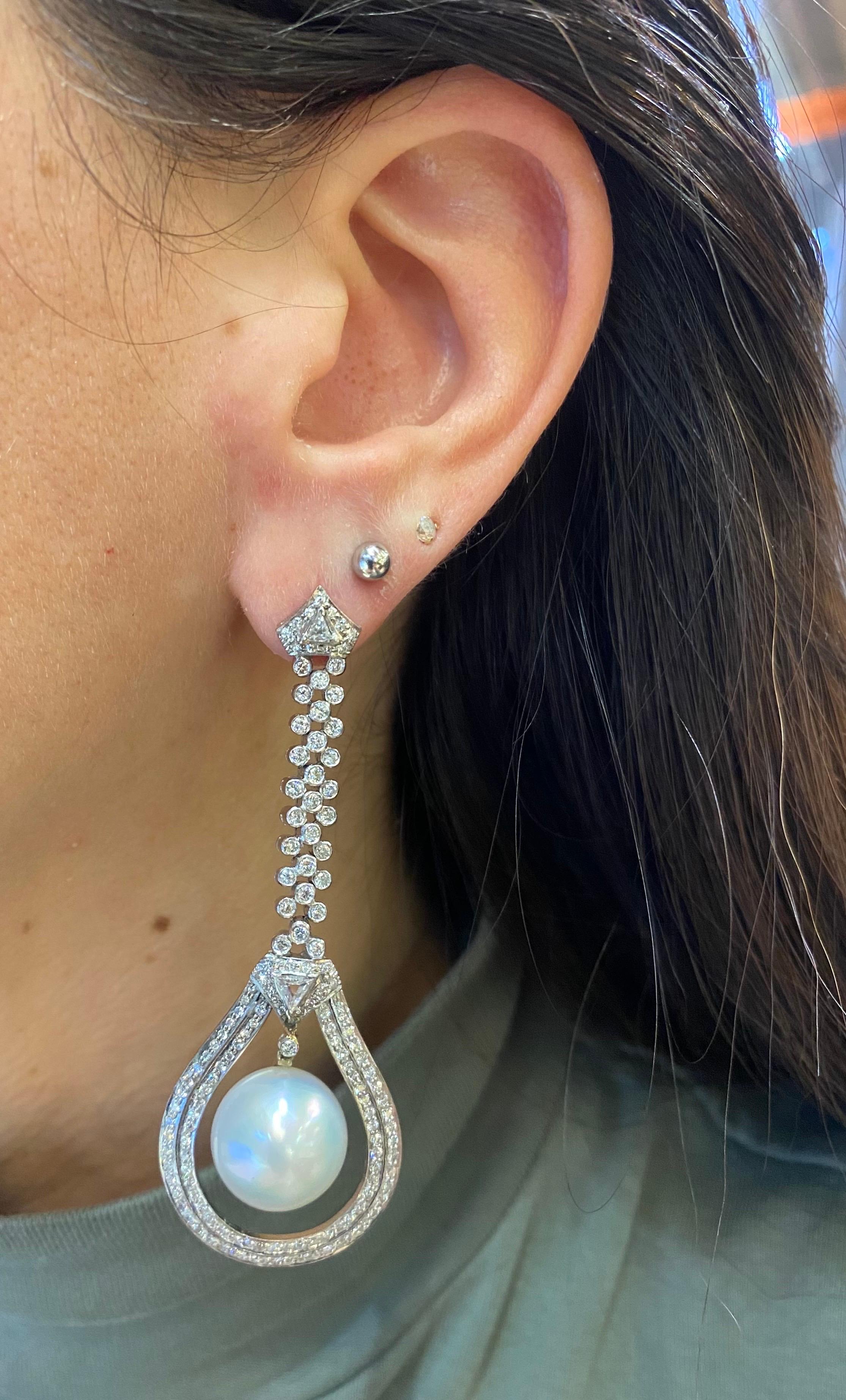 Diamond and Pearl Drop Earrings

A pair of white gold drop earrings set with two pearl drops accented by round cut diamonds. 

Total Approximate Diamond Weight: 4.63 carats
Approximate Length: 2.75