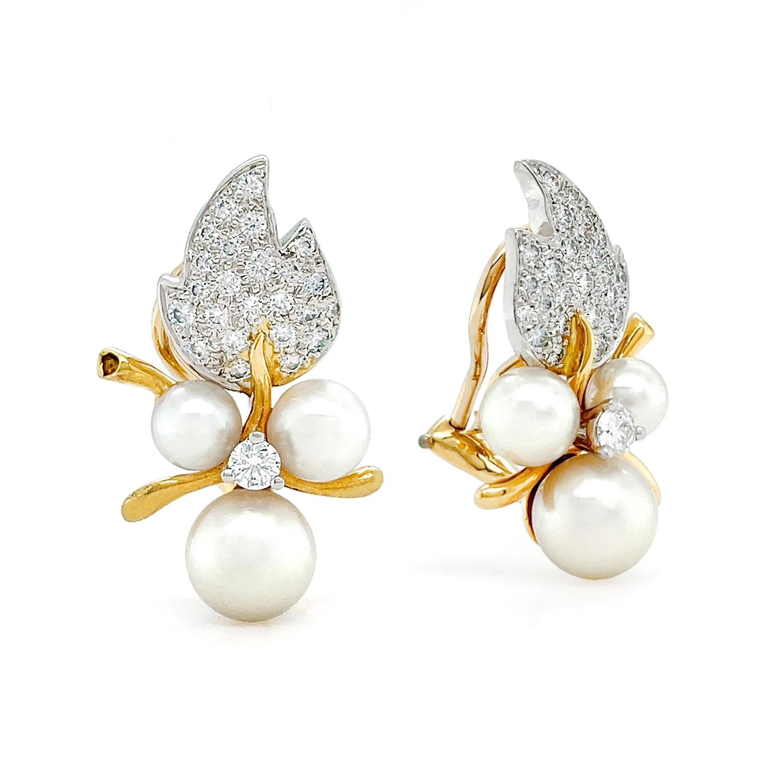 A cluster of berries is imagined in diamonds and pearls. Brilliant cut diamonds set in platinum are a three cornered leaf, while 18k yellow gold serves as the midrib. The gold also acts as the stems. Three round white pearls indicate a cluster of
