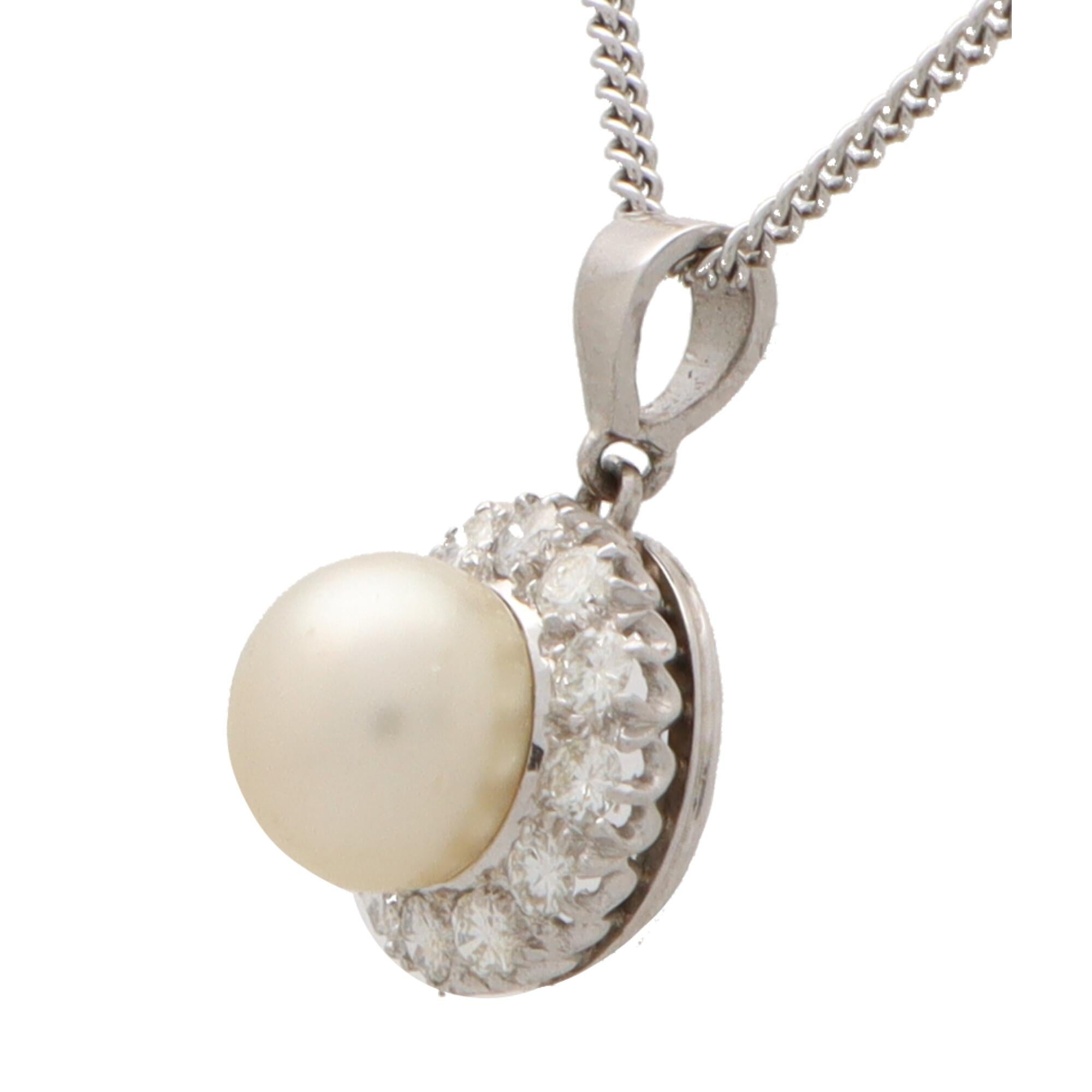 A beautiful diamond and pearl pendant necklace set in 9k white gold.

The pendant is composed of simple circular drop set centrally with a lustrous cream saltwater cultured pearl. The drop is set with a total of 12 round brilliant cut diamonds. It