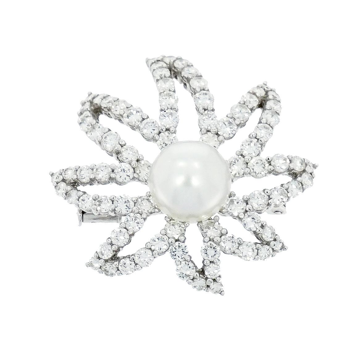 This stunning platinum floral brooch exemplifies classic jewelry, with petals which are set with 80 fine round brilliant-cut diamonds, weighing 5.22 carats and centered by an exquisite 10.5mm white pearl. 