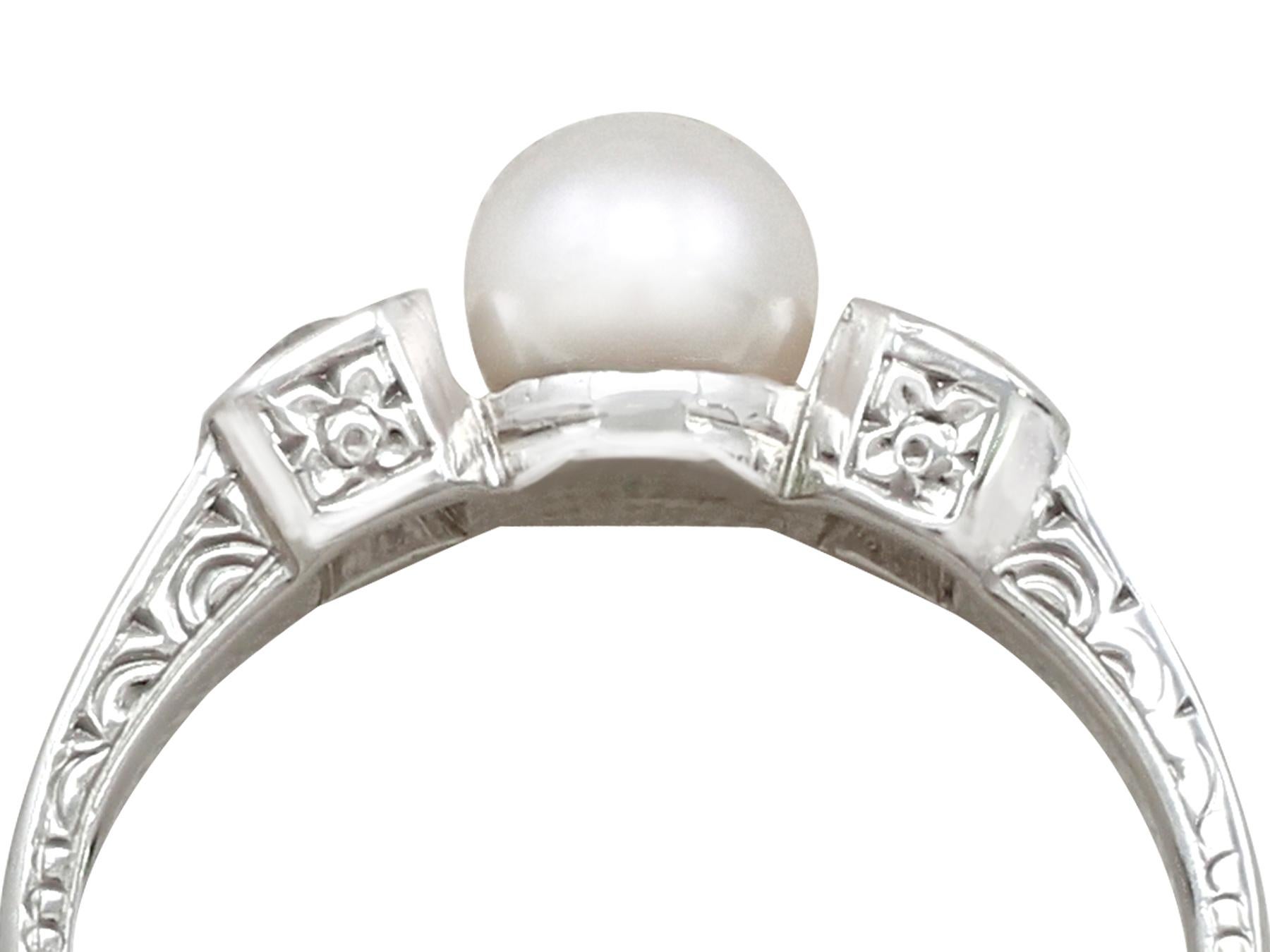 An impressive antique 0.32 carat diamond and pearl, 14 karat white gold trilogy style dress ring; part of our diverse antique jewellery and estate jewelry collections.

This fine and impressive pearl and diamond dress ring has been crafted in 14k