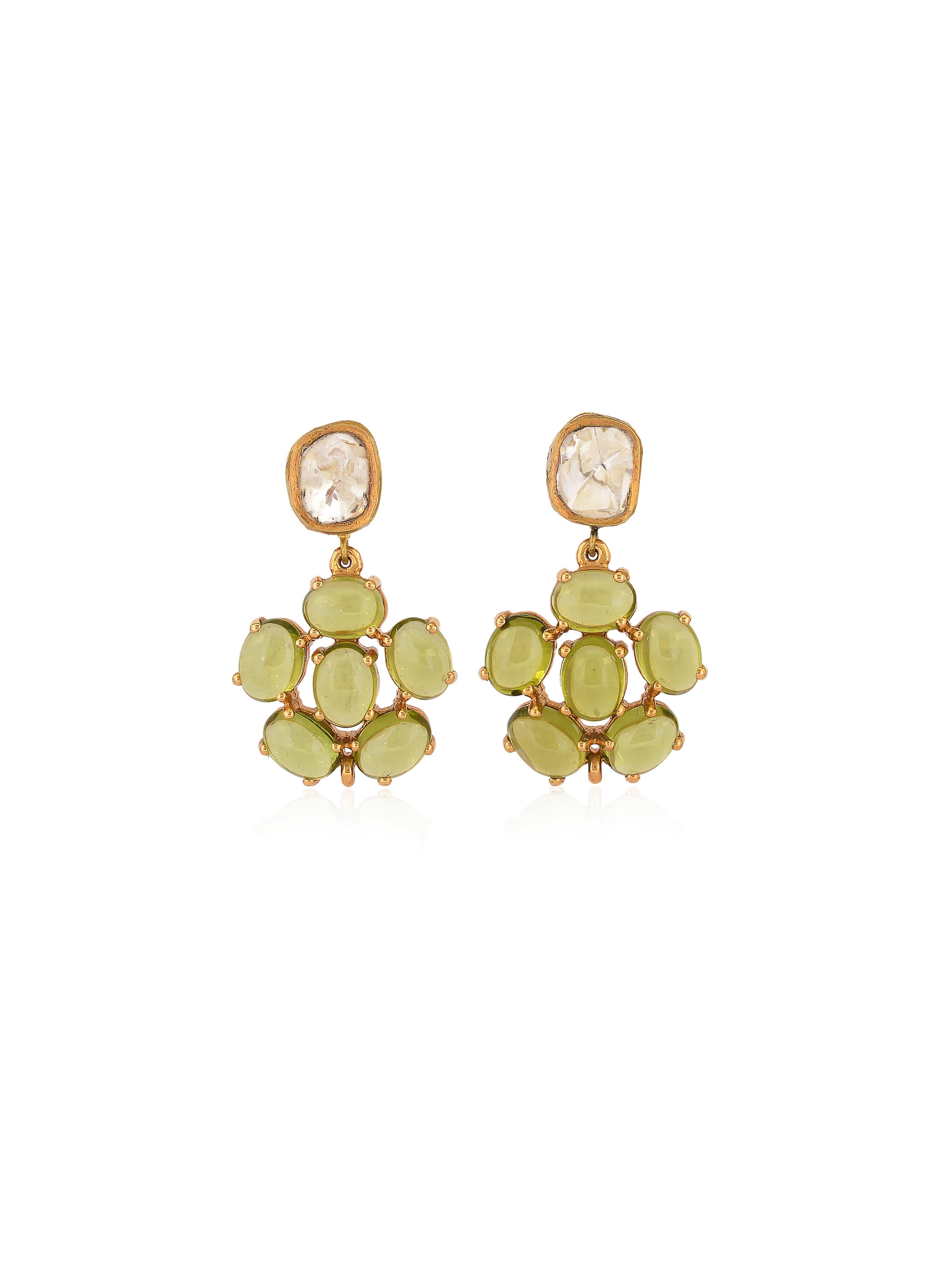 A pair of elegant pastel color peridot and uncut diamonds earrings, The clean peridots are kept hanging to make light pass through them as they look even prettier than they are. 
The top stud is a pair of uncut diamonds set in 18K gold by hand. The