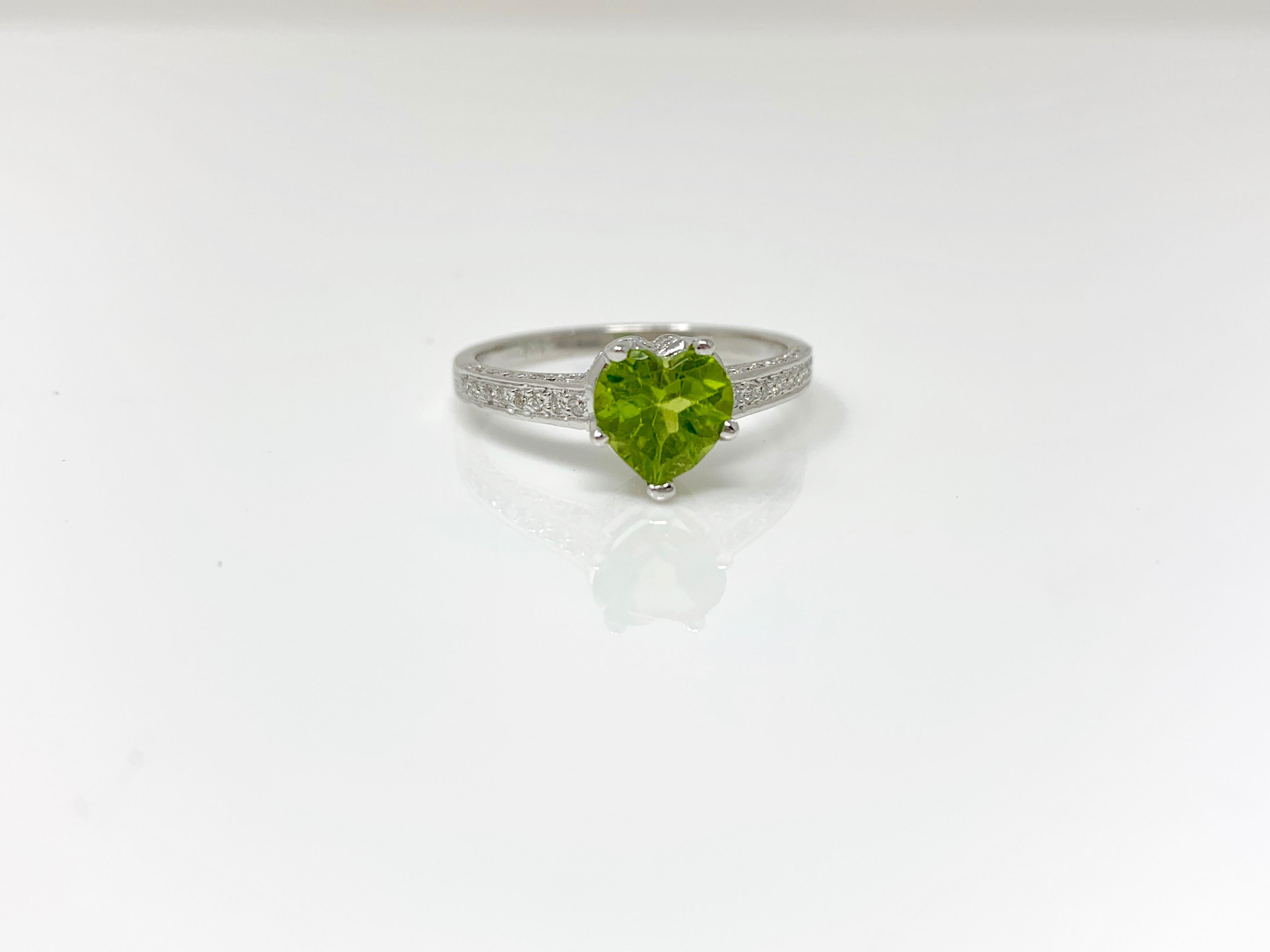This unique and classy heart shape peridot and diamond engagement ring is custom handmade in 18k white gold. 
Peridot weight : 1.25 carat 
Diamond : 0.33 carat
Ring size : 7 