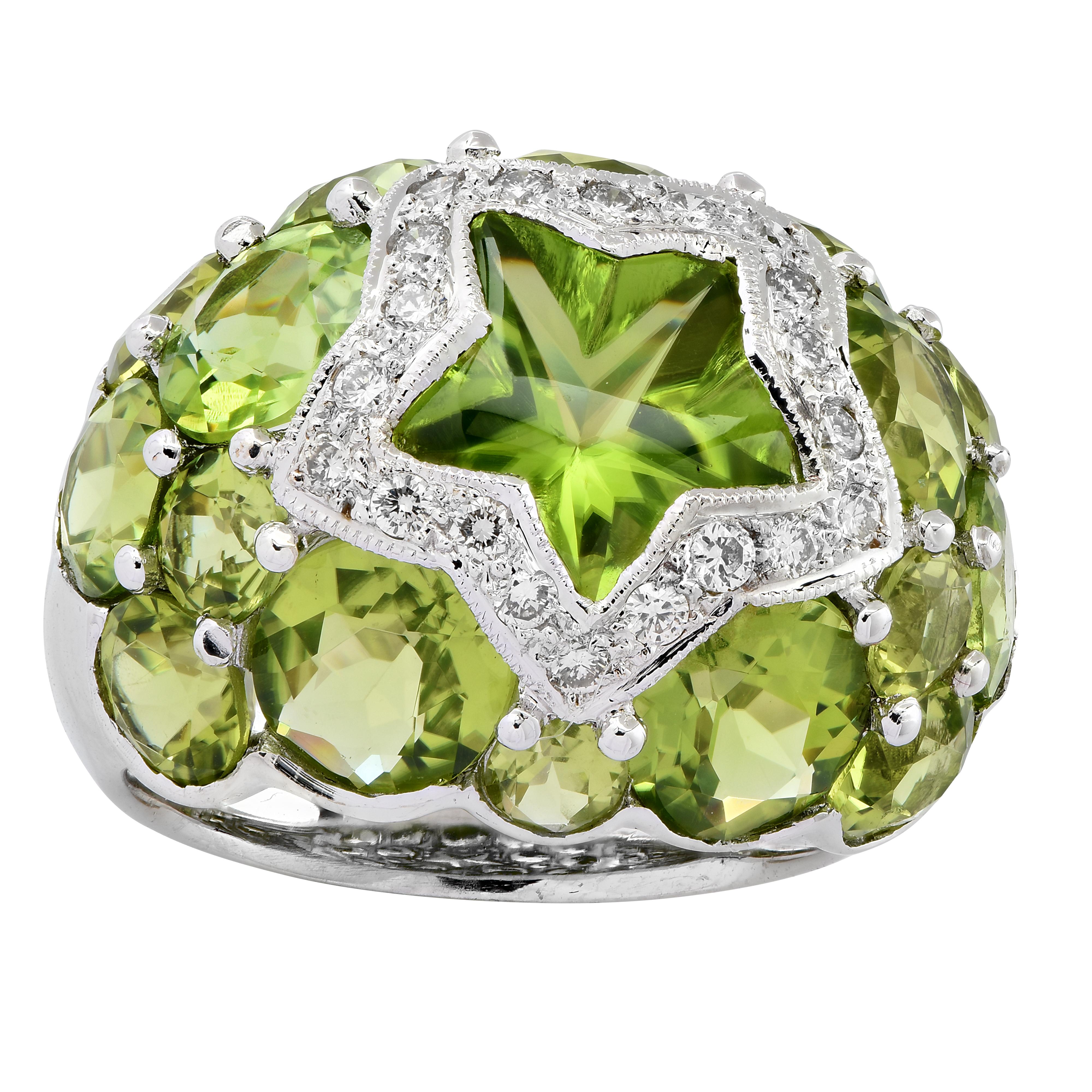 Enchanting ring crafted in 18 karat white gold featuring a star shaped Fantasy cut peridot framed in 20 round brilliant cut diamonds weighing approximately .33 carats total G color, SI clarity, and oval cut peridots. This delightful ring measures