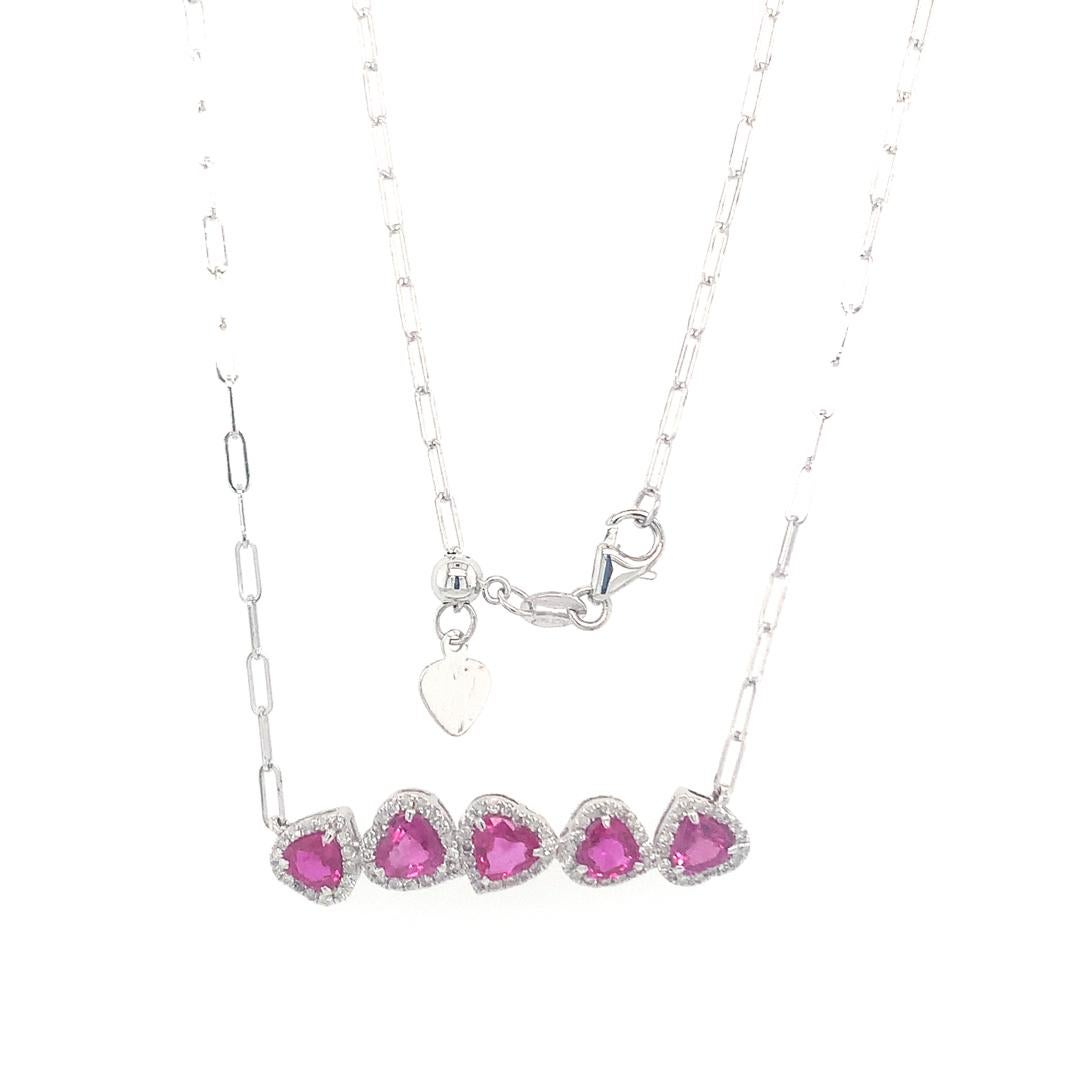 A 0.30-carat diamond surrounds a naturally formed 1.57-carat pink sapphire heart, set in 14-karat white gold and accompanied by an adjustable link chain.
