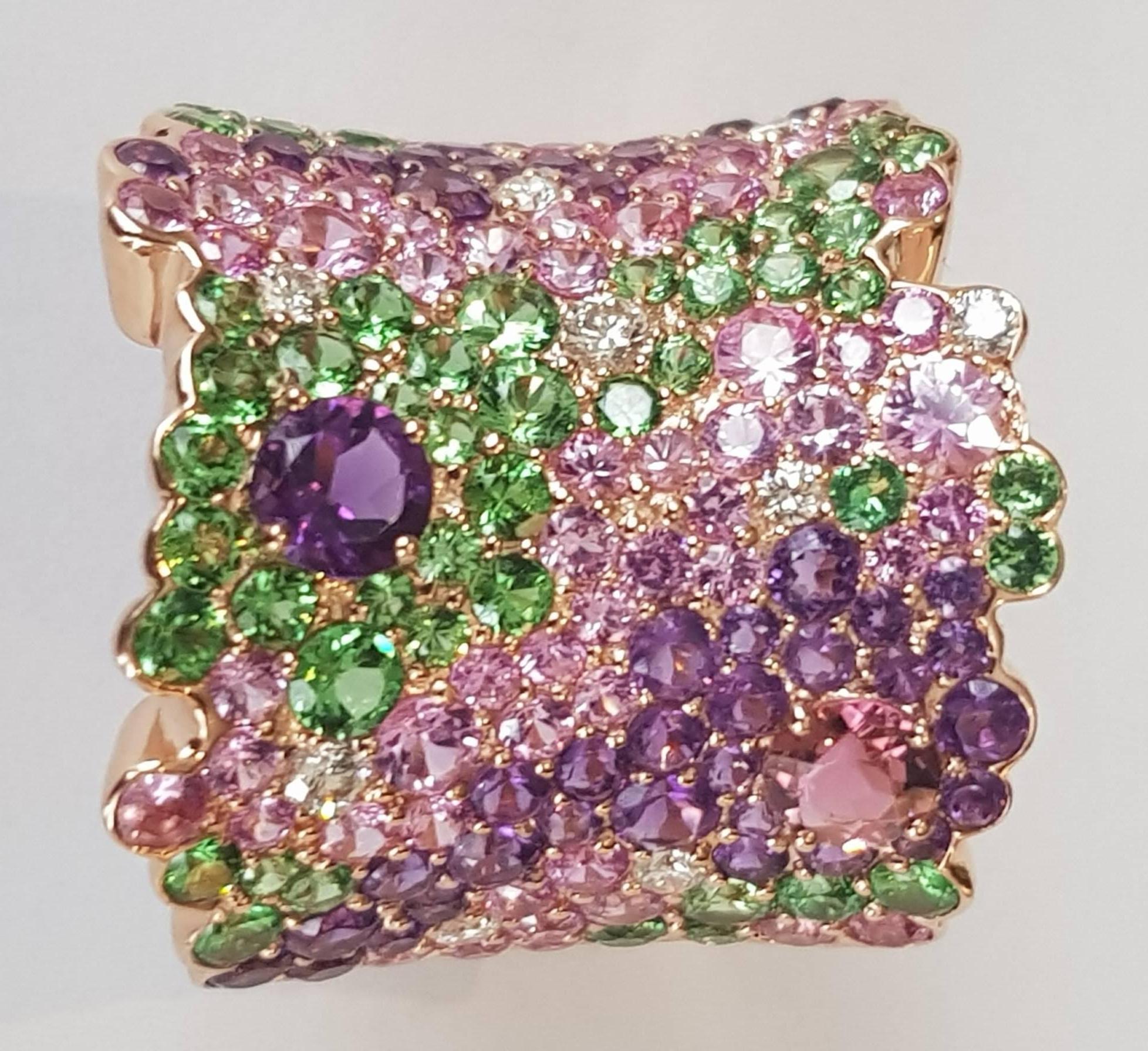 Sapphire, Tsavorite, Amethyst and Diamond Ring
9 diamonds 0.30 ct
61 pink sapphires 2.65 ct
44 amethyst 2.03 ct
46 tsavorites 2.09 ct
1 pink tourmaline 0.30 ct
18 karat rose gold
size 53.5 (can be adjusted one size up or down)