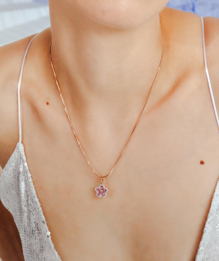 Cherry Blossom Pink Sapphire Diamond Flower Pendant in 18K Gold studded with oval cut pink sapphire. This stunning piece of jewelry instantly elevates a casual look or dressy outfit. 
Sapphire stimulates concentration and reduces stress.
Designed
