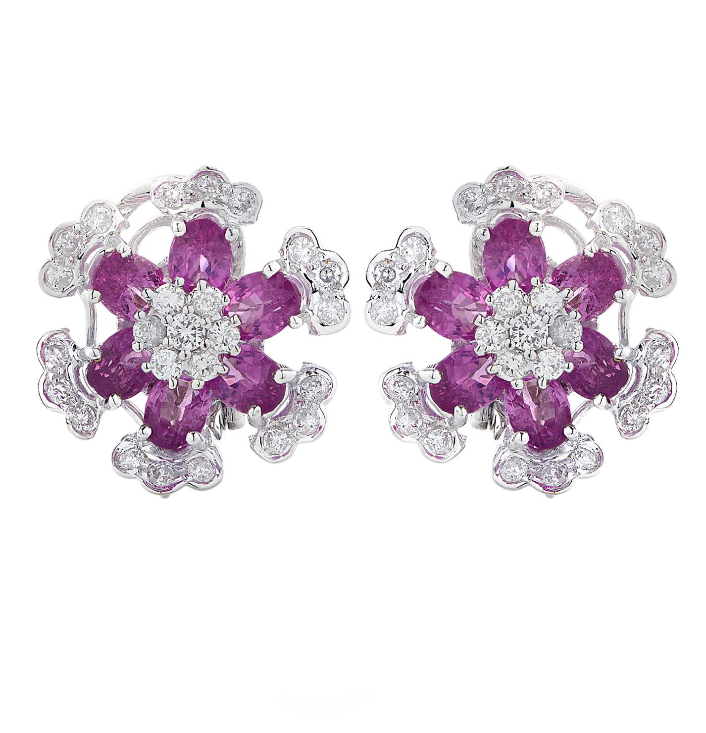 Enchanting earrings crafted in 18 karat white gold featuring 12 oval pink Sapphires weighing approximately 7.55 carats total and 50 round brilliant cut diamonds weighing approximately 1.64 carats total, G-H color, VS-SI clarity. Pink Sapphires are