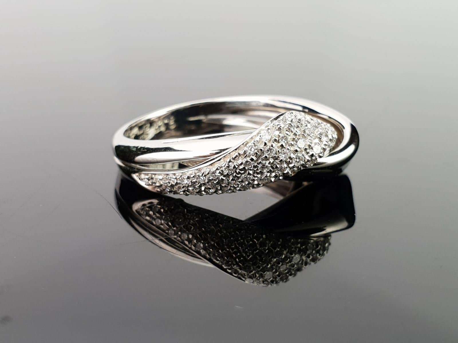 An elegant, modern ring with 0.45 carat white diamonds studded in 9.8grams of platinum. The ring is currently a size US6.5, but can be changed free of charge according to the client. 
