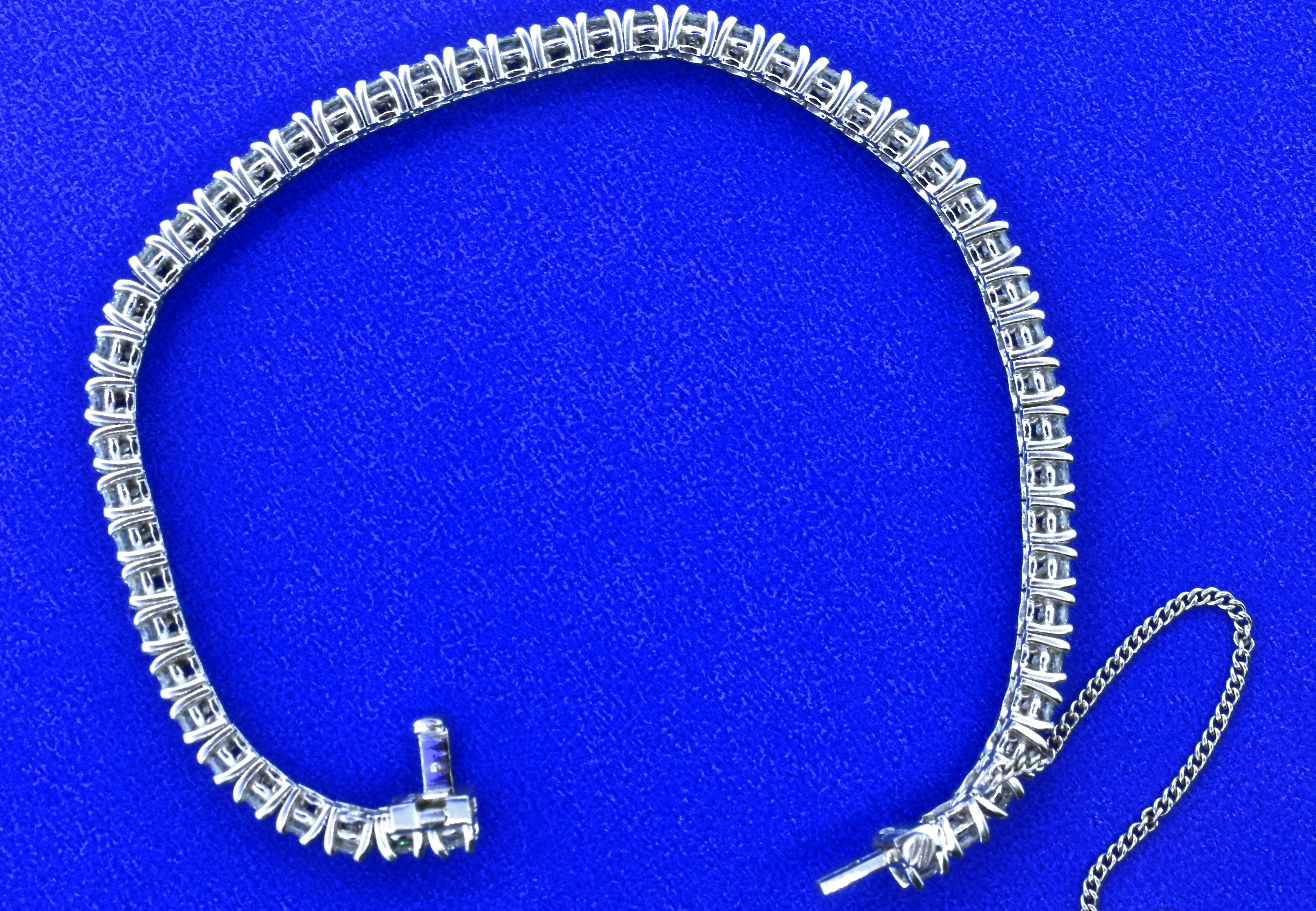 Diamond bracelet with 52 very fine diamonds.  All of the brilliant cut diamonds are well cut, with fine symmetry, color and clarity.  Our in-house GIA gemologist estimates the color of all of these finely matched stones to be G (near colorless), and