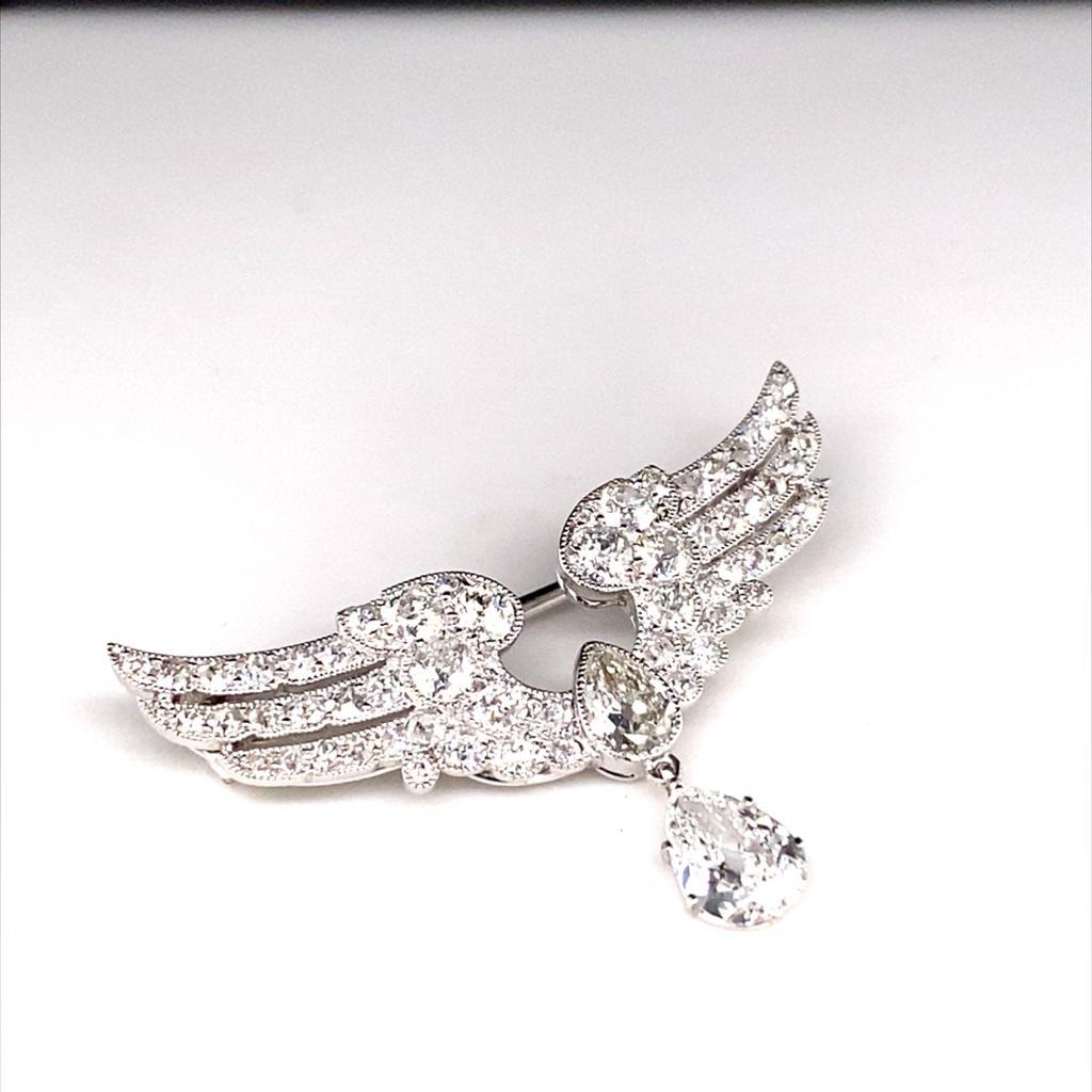 A diamond and platinum brooch by Cartier, circa 1900.

This elegant brooch by Cartier dates from the turn of the last century and is in beautiful condition for its age.

The brooch takes the form of a pair of wings with a central pear shaped diamond