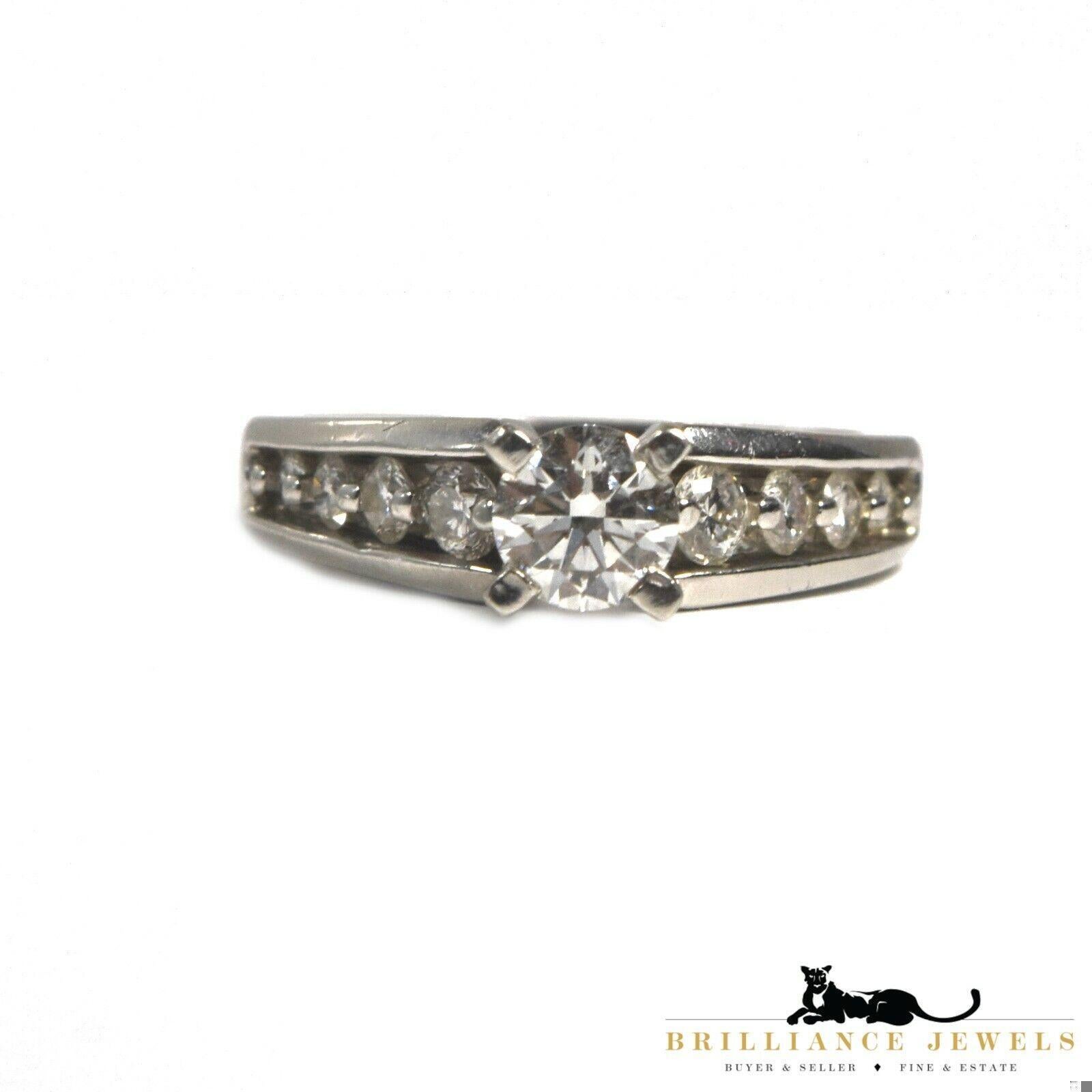 Lovely engagement ring in Platinum offering a vibrant display of approximately 0.85 total carat weight of brilliant cut diamond.

The central stone of approximately 0.65 cts. is elegantly surrounded by 4 smaller ones on each shoulder of the ring. A