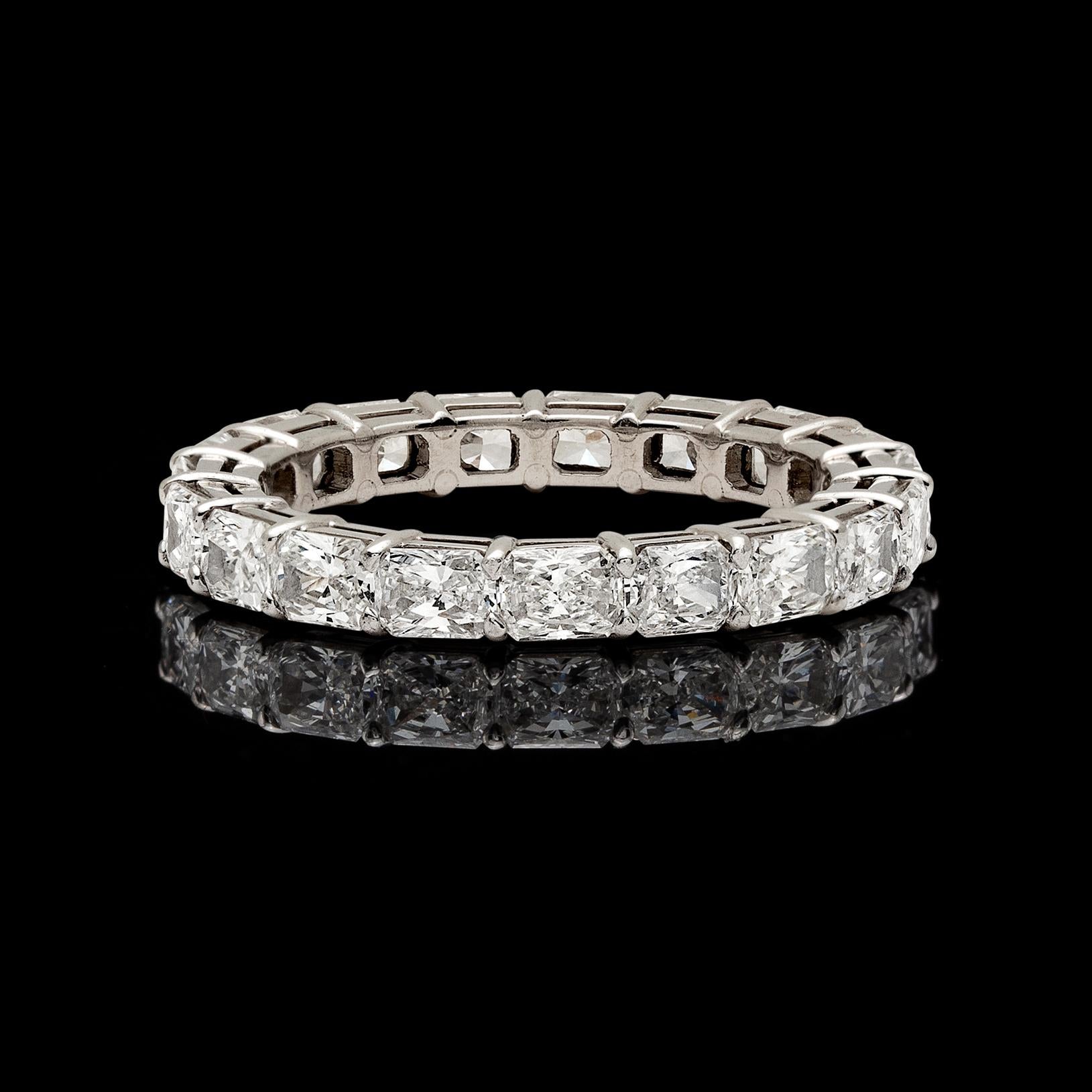 Shipping/Returns
A ring to love for eternity! A unique platinum wedding band featuring 19 radiant-cut diamonds set horizontally fully around the ring. The estimated total diamond weight is 3.40cts,  the ring weighs 3.84 grams, and fits a finger size