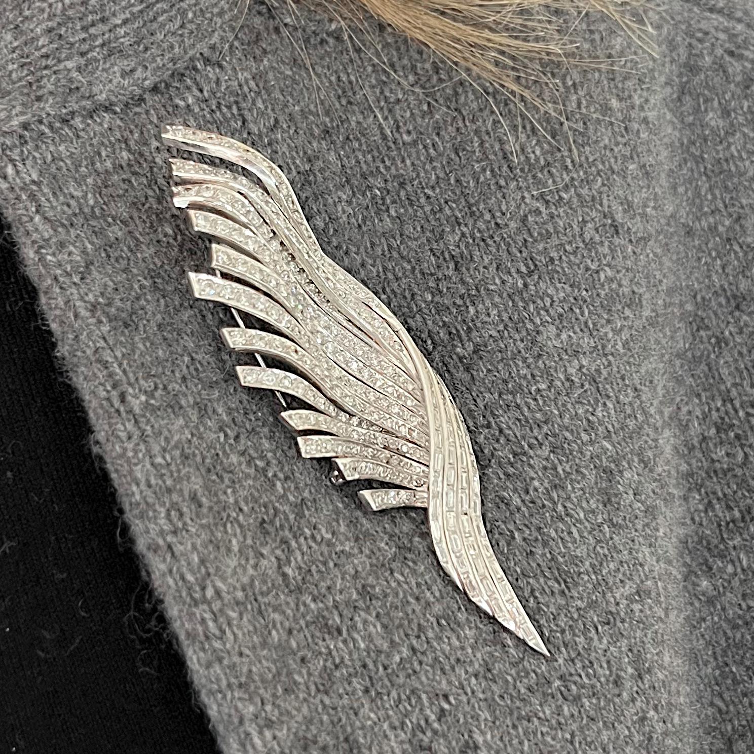 A stylised, diamond set feather brooch, with baguette-cut diamonds in channel settings, and eight-cut diamonds in grain settings, mounted in platinum, with an estimated total diamond weight of 5.40 carats, with a two pronged pin to the reverse.
