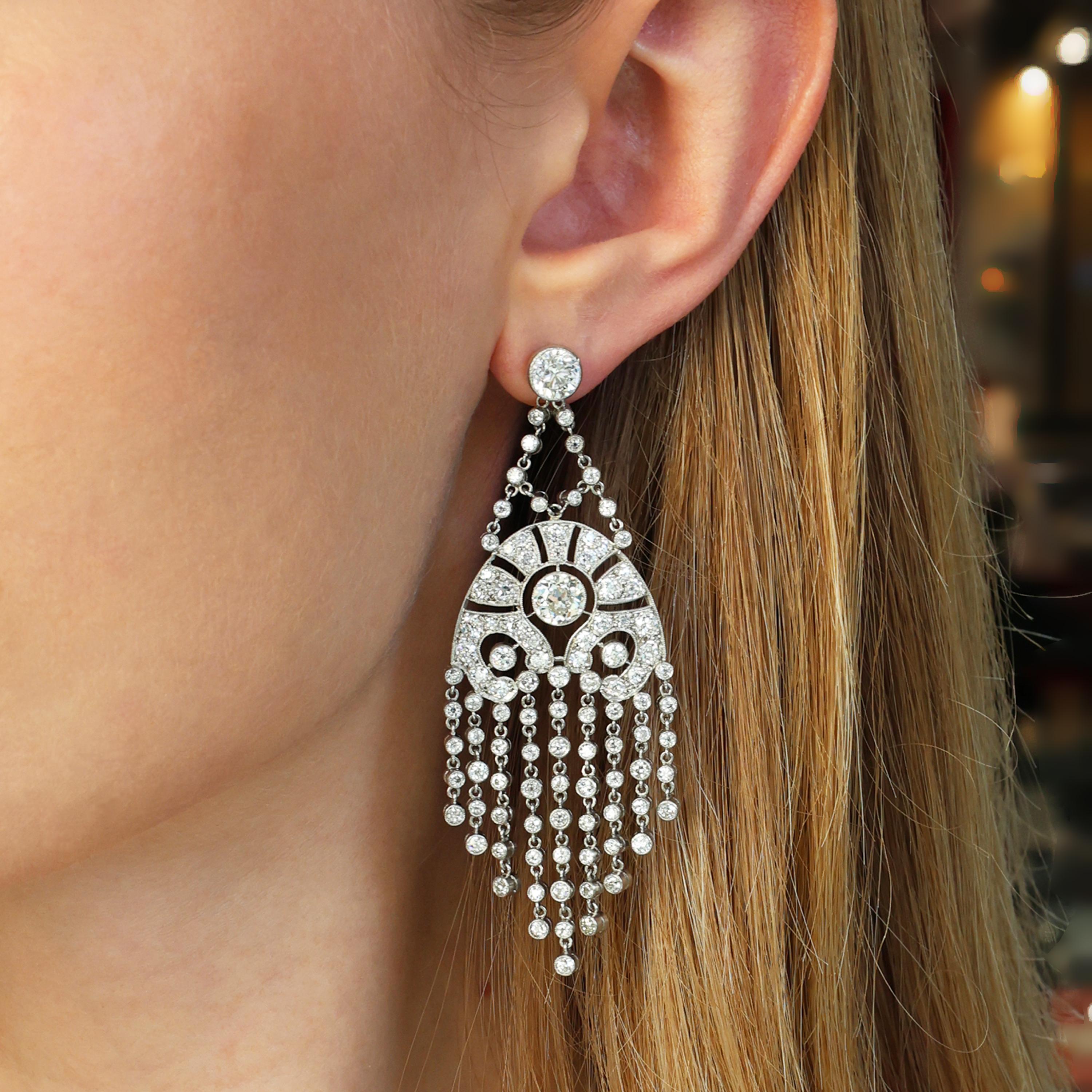 A pair of diamond and platinum fringe drop earrings, with round brilliant-cut diamond tops, weighing 2.00 carats in total, F colour, SI2 clarity, in rub over settings, suspending an interlinked chain of Edwardian-cut diamonds, in rub over settings,