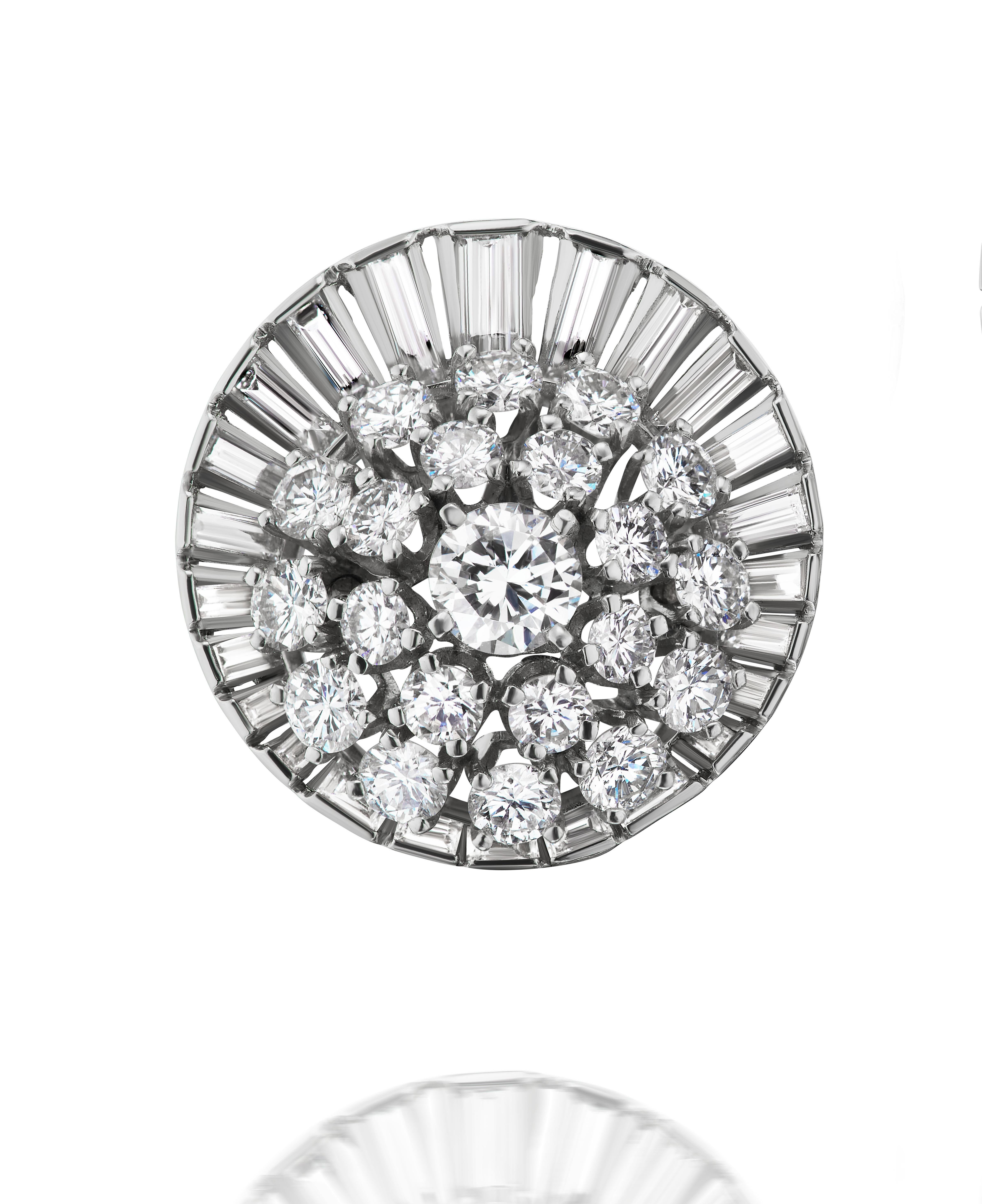 Retro-style round brilliant and baguette diamonds laid out in a distinctive satellite pattern.

This exquisite design consists of approximately 6.70 carats of round diamonds in a natural bombé pattern laid over a baguette halo of approximately 3.50