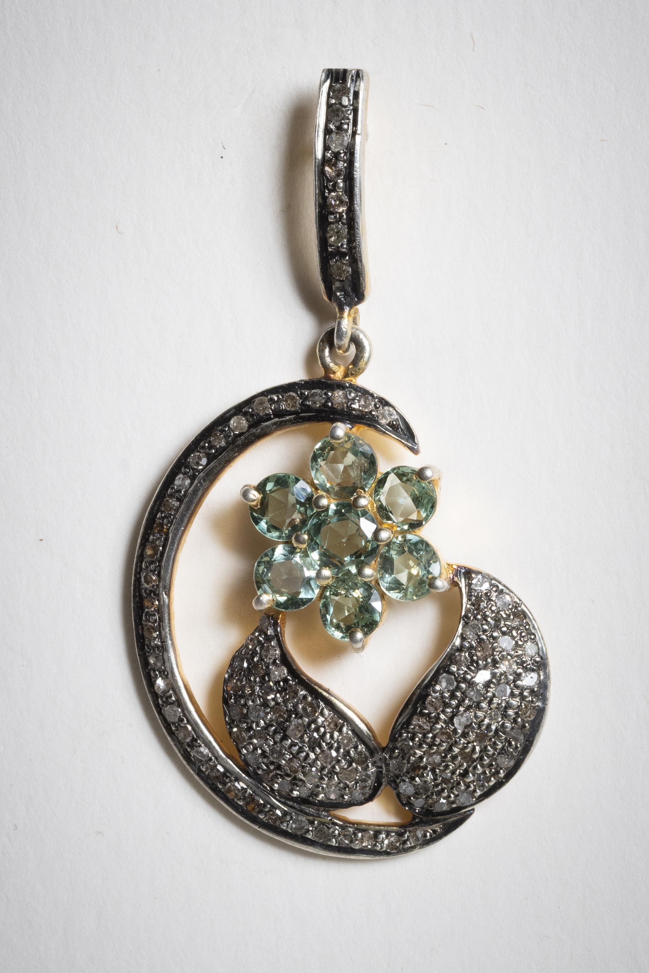 A pair of flower dangle earrings with prasiolite (green amethyst) gemstones as the flower petals and pave` set diamonds on the leaves and the border.  Sterling silver with 18K gold.  For pierced ears.  Diamond weight totals 1.25 carats, the