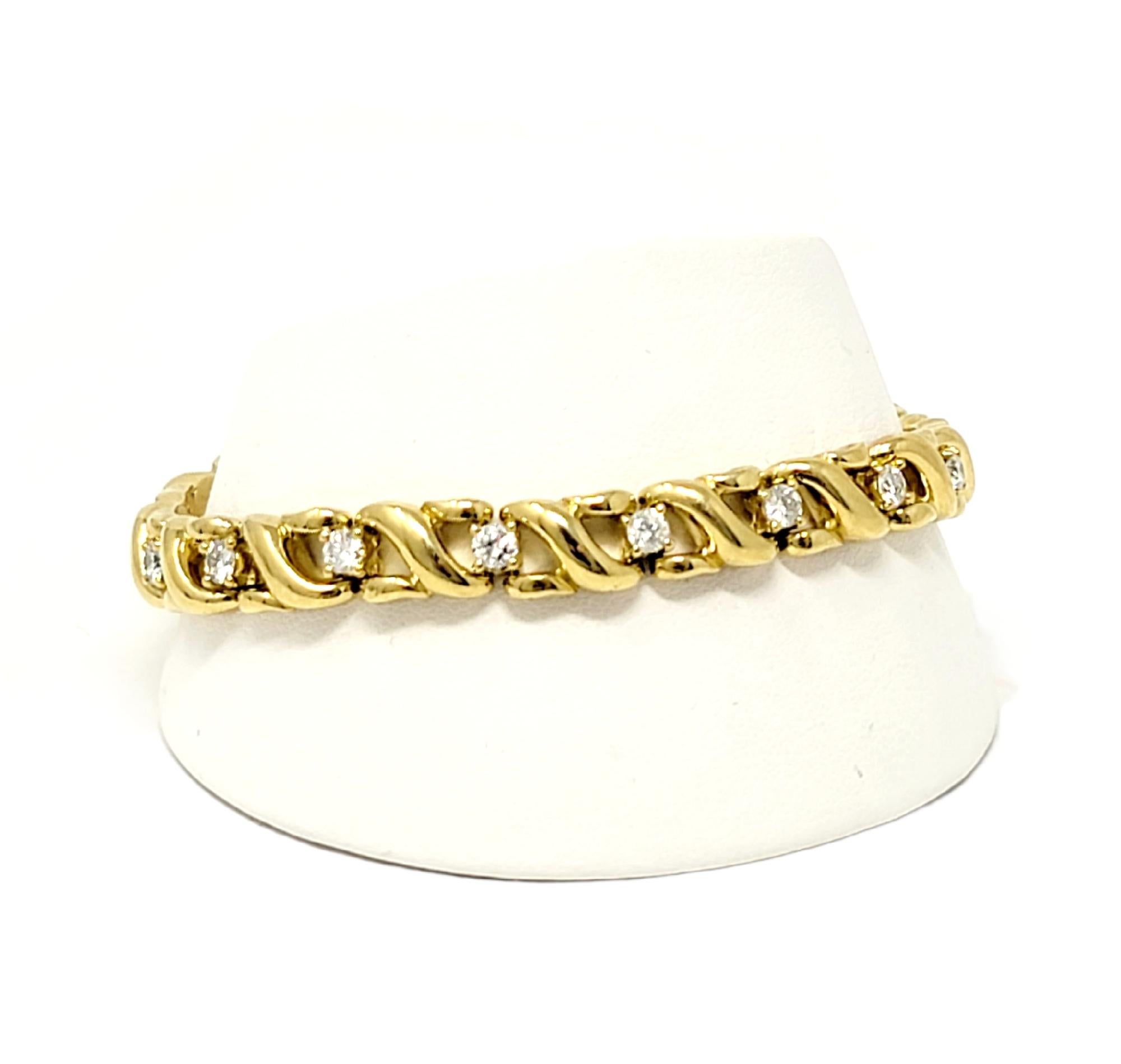 Lovely and feminine diamond and 18 karat yellow gold link bracelet. This timeless piece has a simple yet elegant design that will go with just about everything. It features 17 sparkling round diamonds, G-I in color, VS2-SI2 in clarity, and totaling