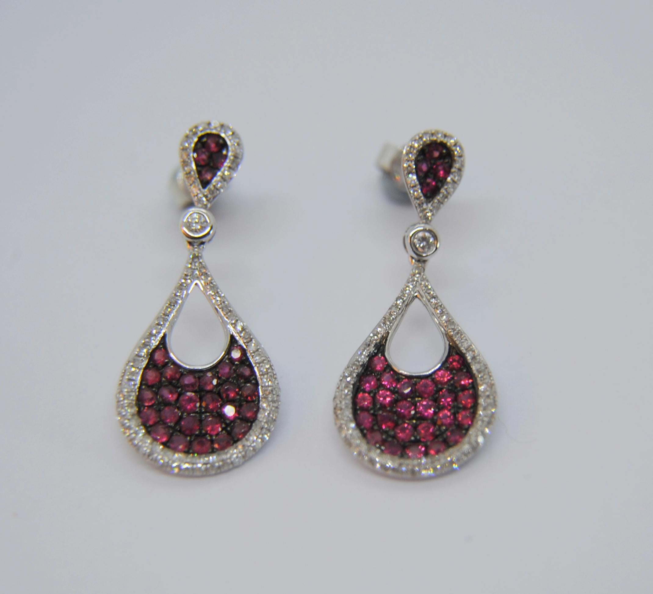 READY TO SHIP
*Shipment of this piece is not affected by COVID-19. 
Orders welcome!*
These pair of 18k white gold dangle earrings weight 4.4grams and measure 28mm or 1.15 inches
The pavé of rubies are 58 x 0,017ct  total 1,03ct pair 
 and 162