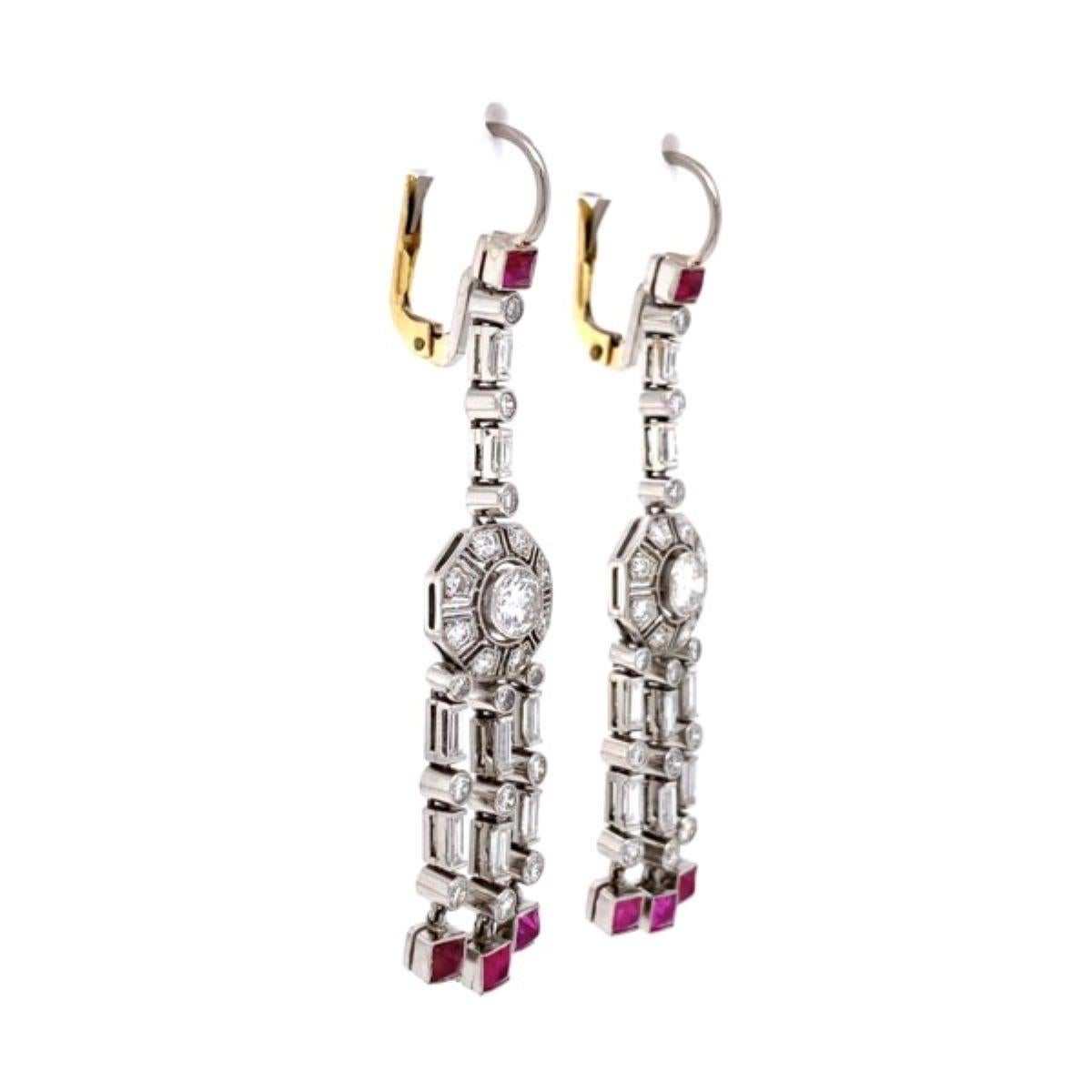 Stunning Diamond and Ruby Platinum Drop Dangle Earrings. Hand set with 8 buff top Rubies approx. 1.20tcw with alternating 16 baguette Diamonds approx. 0.62tcw and 40 round Diamonds approx. 0.80tcw and 2 round Diamonds approx. 0.70tcw. Diamonds