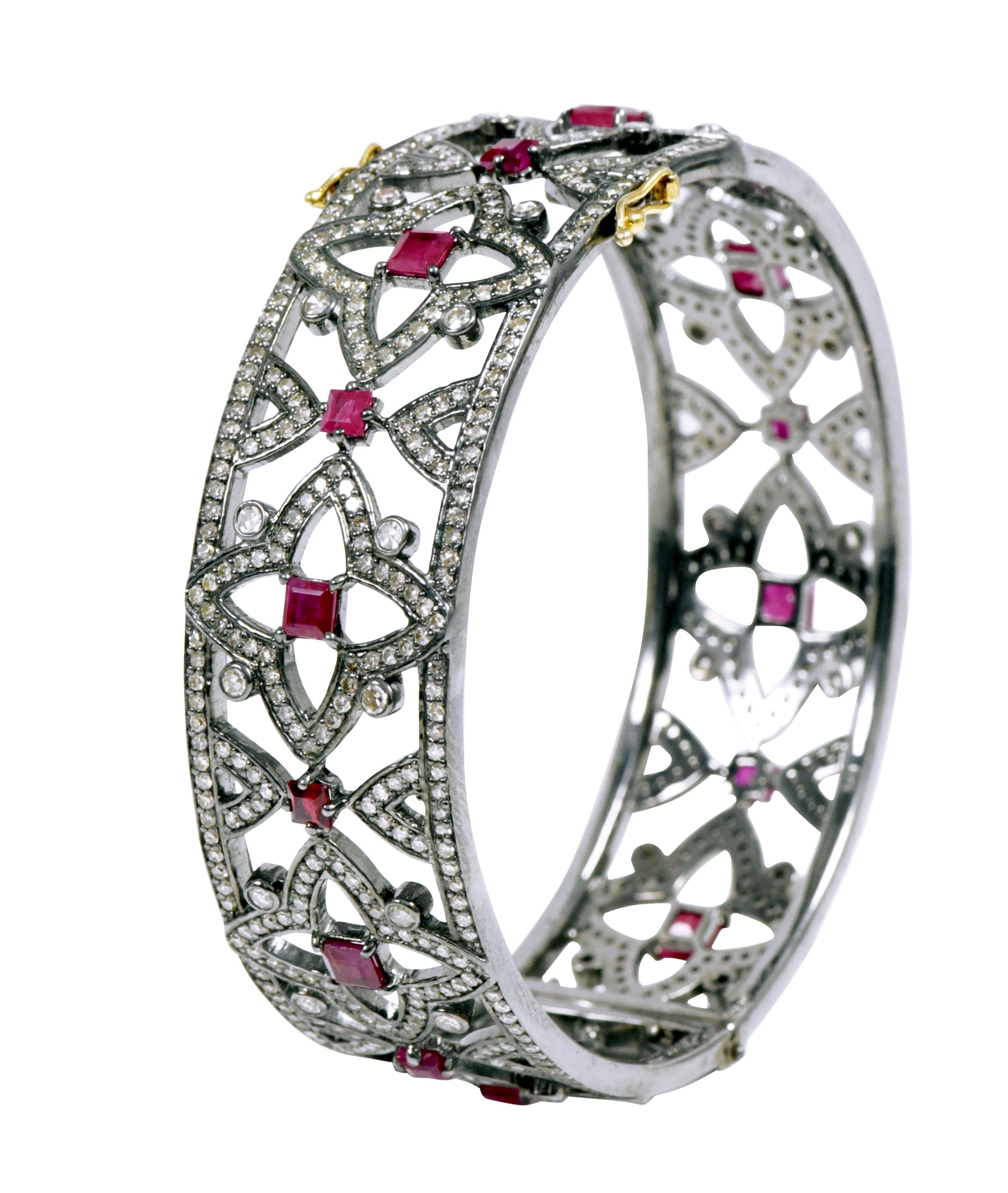 Diamond and Ruby 10.60 Carats Bangle in Victorian Style

Inspired by the Victorian Era, this art-deco style bangle is timelessly elegant. Created by a feat of fine craftsmanship and imagination, this magnificent design features a star shape