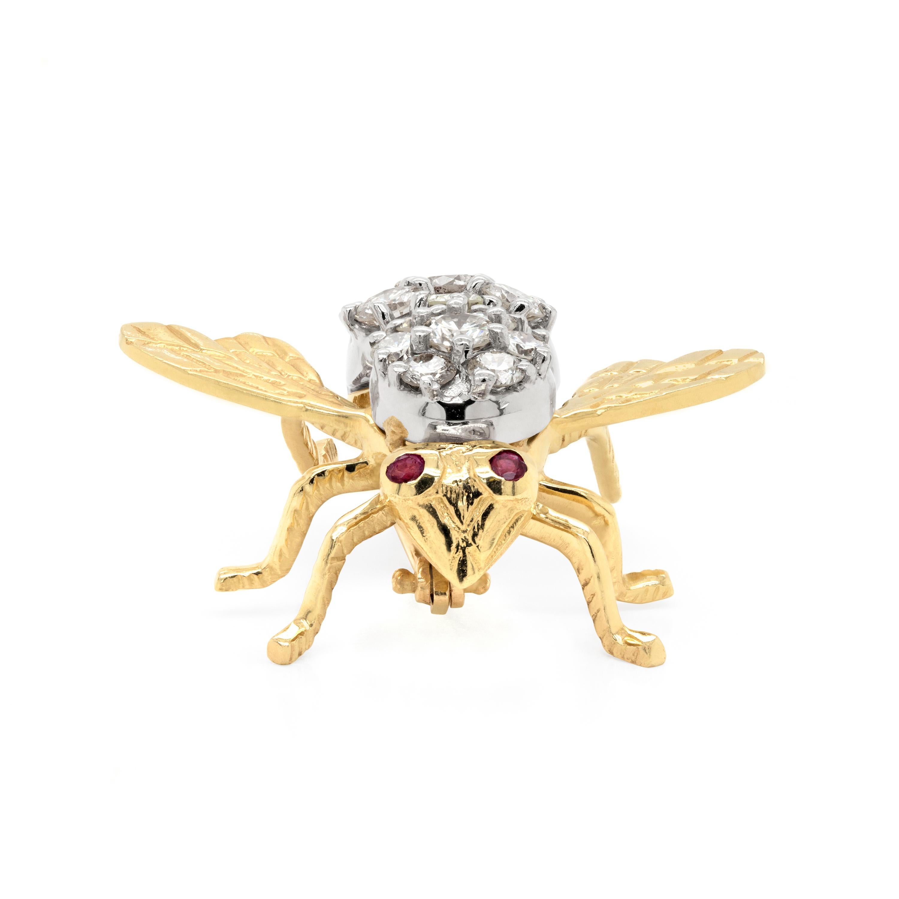 This charming brooch is inlaid with 19 round brilliant cut diamonds, all claw set inside the bug's body, totaling to an approximate weight of 2.00 carat. The bee is further set with two round cut rubies rub over set for its eyes. The upper part of