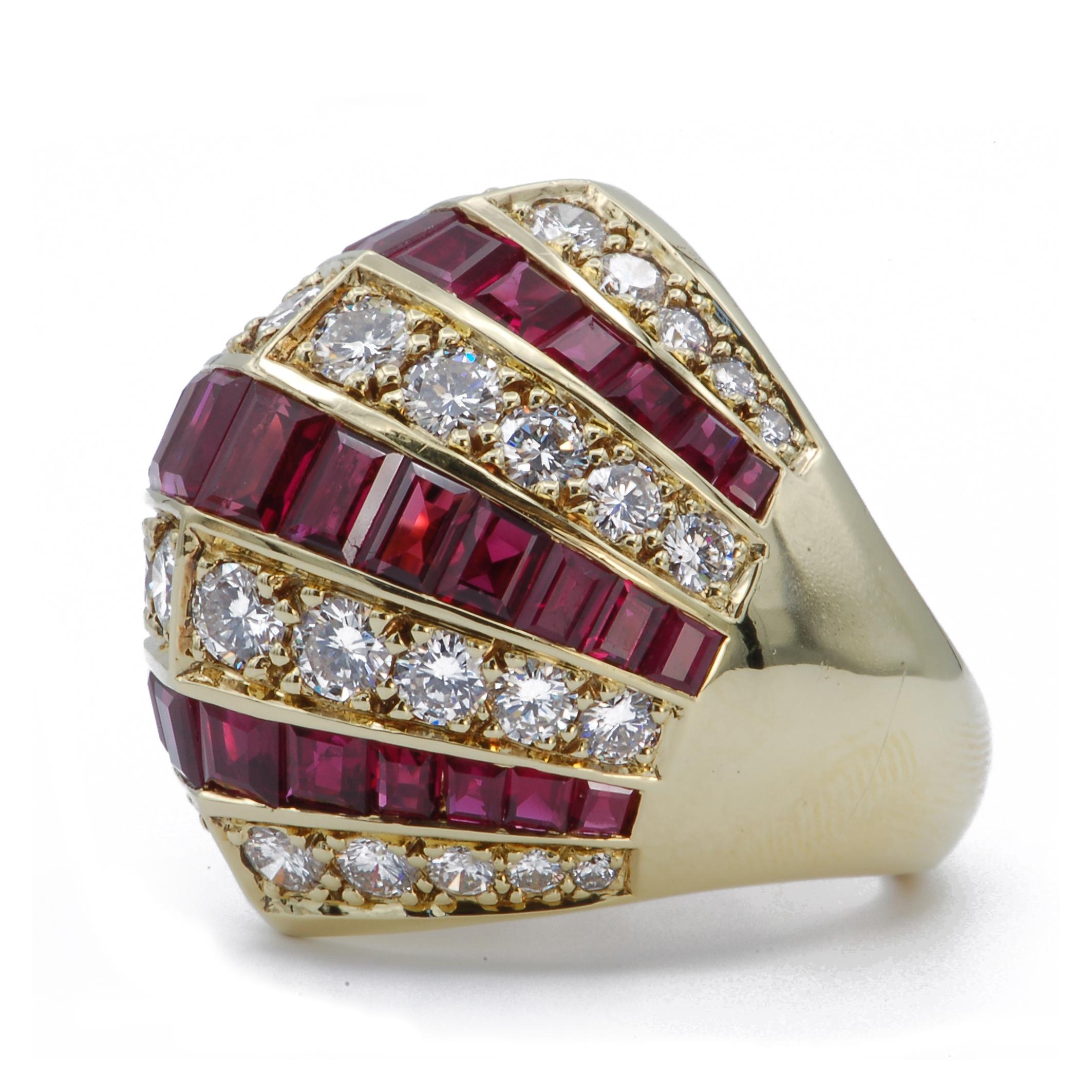 This 18k yellow gold cocktail ring makes a grandiose statement with its unique peaked center line. The graduating rows of square cut rubies and round brilliant cut diamonds accentuate the domed design.  Inside the ring is a rectangular pattern