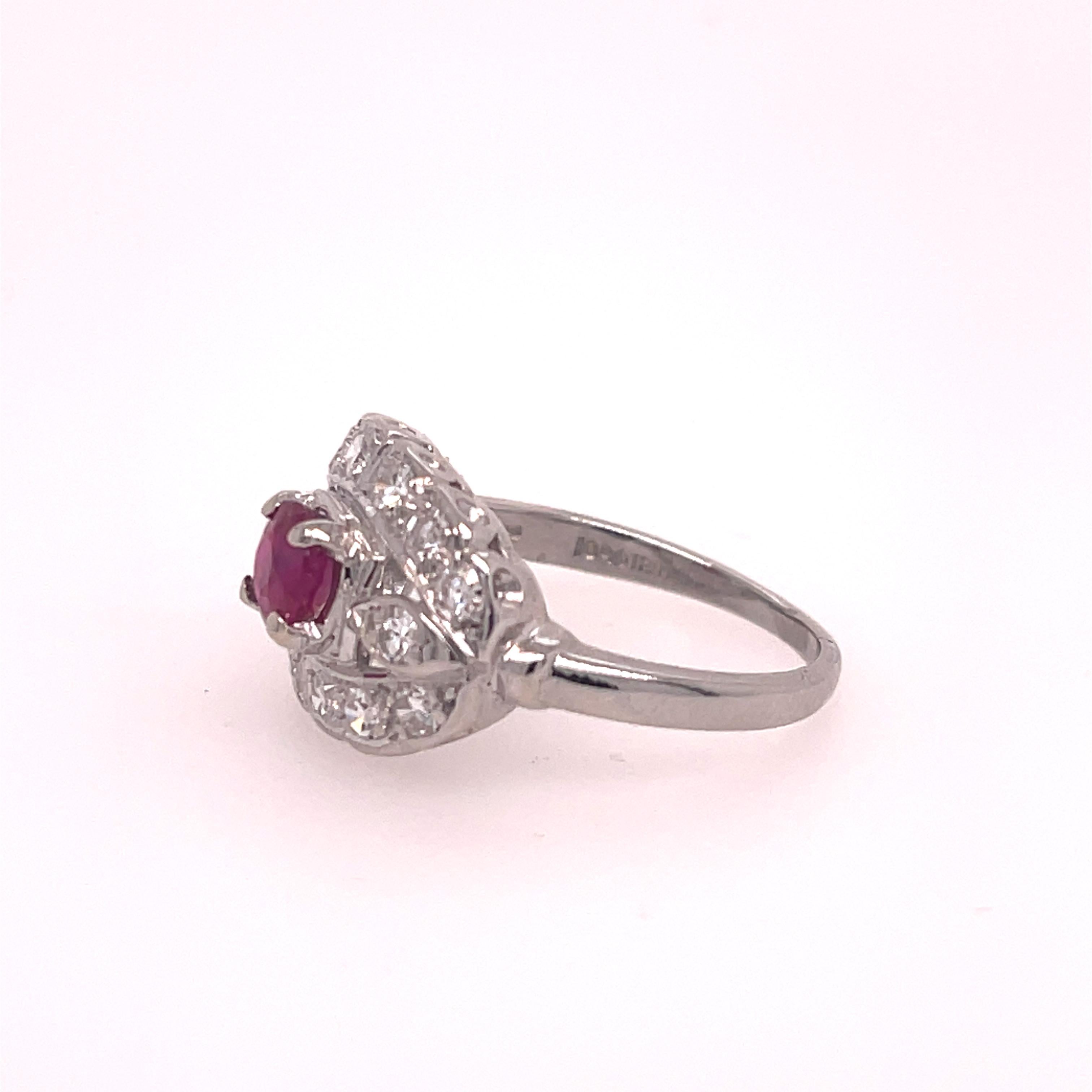 Ladies Diamond and Ruby Art Deco Ring in Platinum.  The ring features a .61 natural round full cut ruby, AA quality.  Complimenting the center stone are 14 single cut round diamonds, approximately 1/4 carat total weight, G-H in color and SI1 in