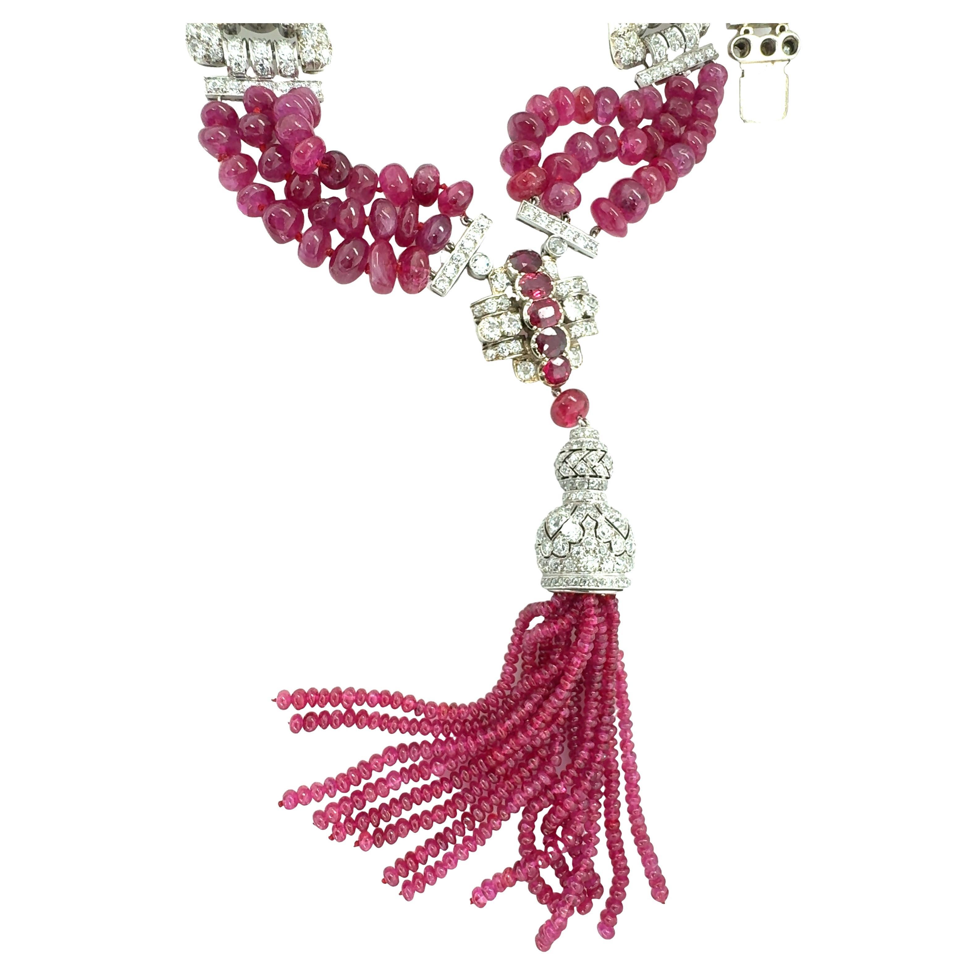 One Art Deco triple strand diamond and ruby bead tassle necklace / pendant set in platinum and 18k white gold by Tiffany & Co.  Featuring old European cut and old mine cut diamonds totaling 20.32 ct. with I-J-K color and VS-1 to SI-1 clarity. Also