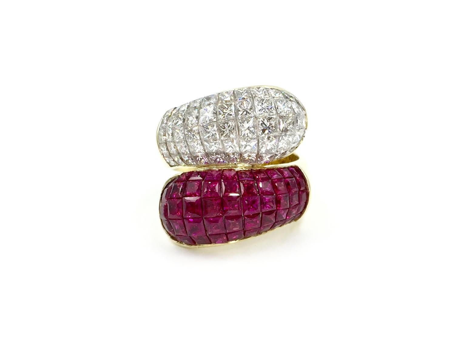 A show stopper from the masters of illusion-set fine jewelry, Quadamas. This gorgeous 18 karat gold bypass style ring features 9.64 carats of stunning princess cut candy apple red rubies and 4.24 carats of high quality princess cut diamonds,