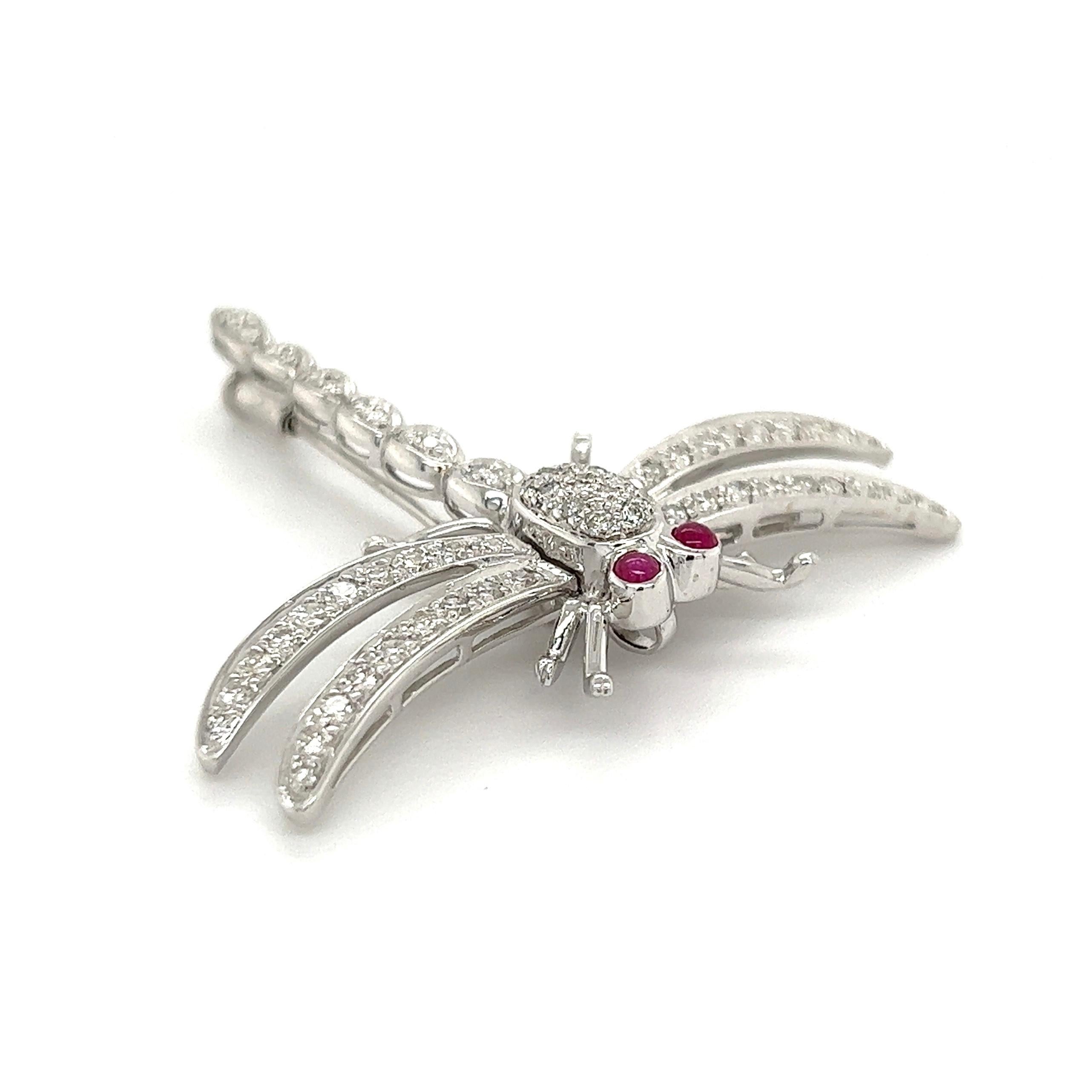 Simply Beautiful! Diamond Dragonfly with Ruby Eyes Brooch. Encrusted with Hand set Diamonds, weighing approx. 1.00tcw, Hand crafted in 18 Karat White Gold. Approx. size: 1.75” tall. This pin is in excellent vintage condition and recently